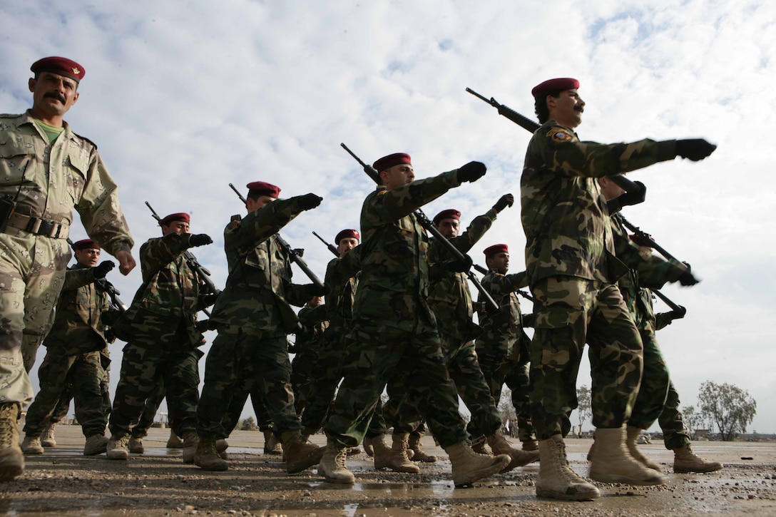 Iraqi soldiers with 2nd Regiment, 2nd Brigade, 1st Division, practice marching for their graduation ceremony aboard the Iraqi Training Center in Al Anbar province, Iraq, Feb. 15, 2008. The Iraqis are trained by U.S. Marine Military Transition Team, 2nd Battalion, Regimental Combat Team 1, to operate in the Northern part of Iraq. RCT-1 is deployed with Multi National Force-West in support of Operation Iraqi Freedom in the Al Anbar province of Iraq to develop Iraqi Security Forces, facilitate the development of official rule of law through democratic reforms, and continue the development of a market-based economy centered on Iraqi reconstruction.