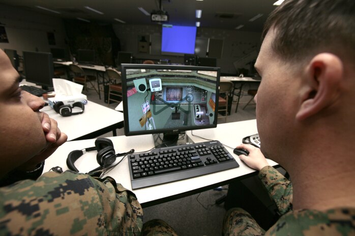 Indoor Small Arms Range personnel examine the simulated interior of a light armored vehicle (LAV) through a computer screen brought to them by Combined Arms Staff Training representatives from Okinawa. The representatives were here Feb. 12-15 to school up ISAR trainers on the equipment?s future implementation on the air station.