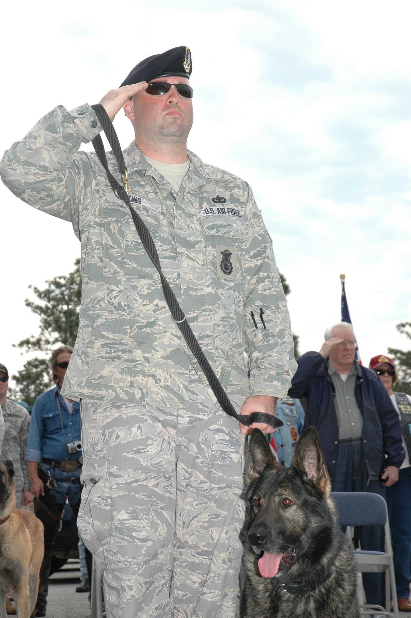 Tech. Sgt.  Gary King and his partner pay respect to all working dogs during the ceremony at the Air Armament Museum today.  (USAF phot/Staff Sgt. Stacia Zachary)
