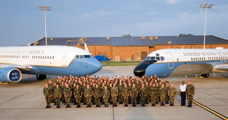The maintenance members of the 932nd Airlift Wing, an Air Force Reserve Command unit, standby next to the two planes they maintain.  At left is the C-40C and at right is the C-9C.  Call 1-800-257-1212 for more information on openings and training required.