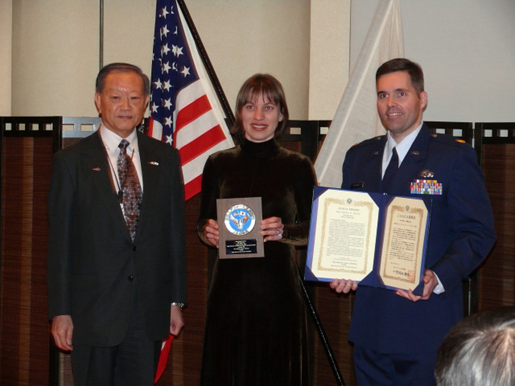 MISAWA AIR BASE, Japan -- Maj. Michael Birdwell (right), 35th Operations Support Squadron, poses with his wife and JASDF Lt. Gen. (ret.) Ohkushi after receiving the Japan-America Air Force Goodwill Association annual award here Feb. 15, 2008. JAAGA is an organization composed of primarily JASDF veterans whose goal is to promote friendship and mutual understanding between JASDF and the U.S. Air Force. Major Birdwell was recognized for his contributions toward the organization's goal. (Photo courtesy of JASDF)