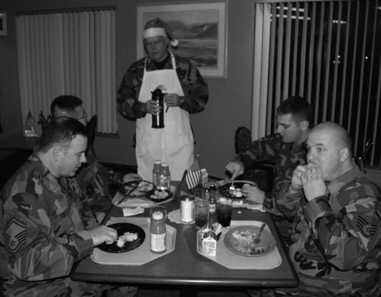 Illinois Air Force Reservists enjoy a "cracked egg" breakfast served by 932nd Airlift Wing Command Chief Master Sergeant Merle Lyman in December, 2007.  Photo/Tech Sgt. Danny Oliver