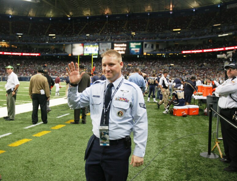 Senior Airman Kenneth Wolf of the 932nd Airlift Wing is shown waving to the crowd in the Edward Jones Dome as he was recognized for his service during a Saint Louis Rams NFL football game.  

He is shown reacting to the applause of the 60,000 people who attended the game as his image was shown on the jumbo size screen.
"It reminded me of why I joined. For a small town guy from Millstadt, it was neat getting a standing ovation. People really do support us in the military," he said.  Photo submitted.