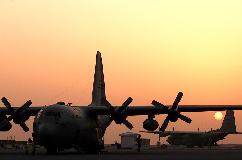 SOUTHWEST ASIA -- A C-130 Hercules aircrew takes in a sunset at a Southwest Asia air base on Feb. 12, 2008. The aircrew is responsible for transporting cargo and passengers throughout the deployed theater supporting Operations Enduring and Iraqi Freedom. (U.S. Air Force photo/Staff Sgt. Patrick Dixon)