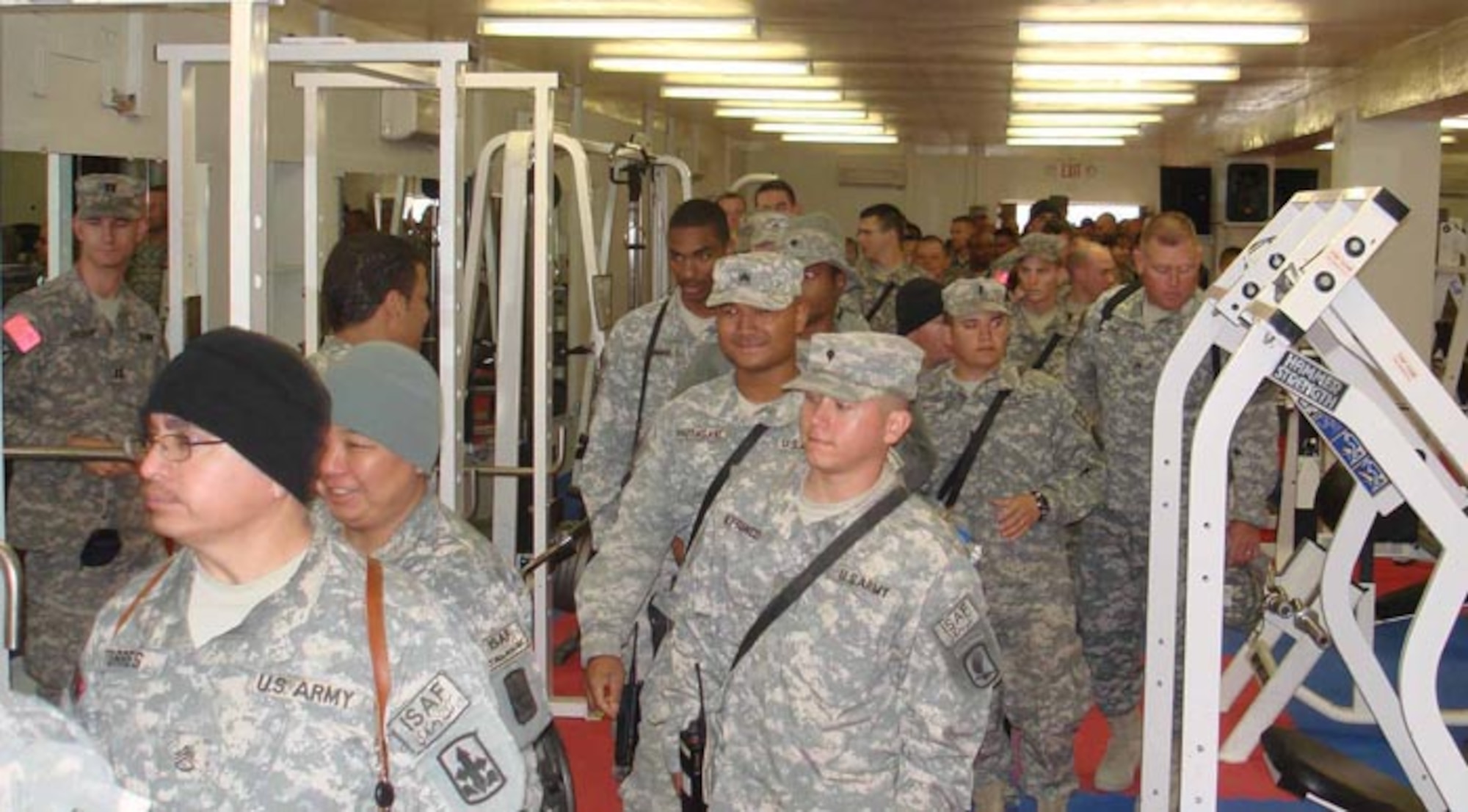 LAGHMAN PROVINCE, Afghanistan--Soldiers and Airmen tour the newly renovated fitness center here Feb 14.  The fitness center was remodeled and renamed in honor of Army Staff Sgt. Charles R. Browning, 1st Battalion, 158th Infantry.  Sergeant Browning was assigned to the Methar Lam Provincial Reconstruction Team and was killed June 1, 2007 when an improvised explosive device detonated under the vehicle he was riding in killing him instantly and wounding four others.  (Photo by Air Force Captain Heather Kekic)   