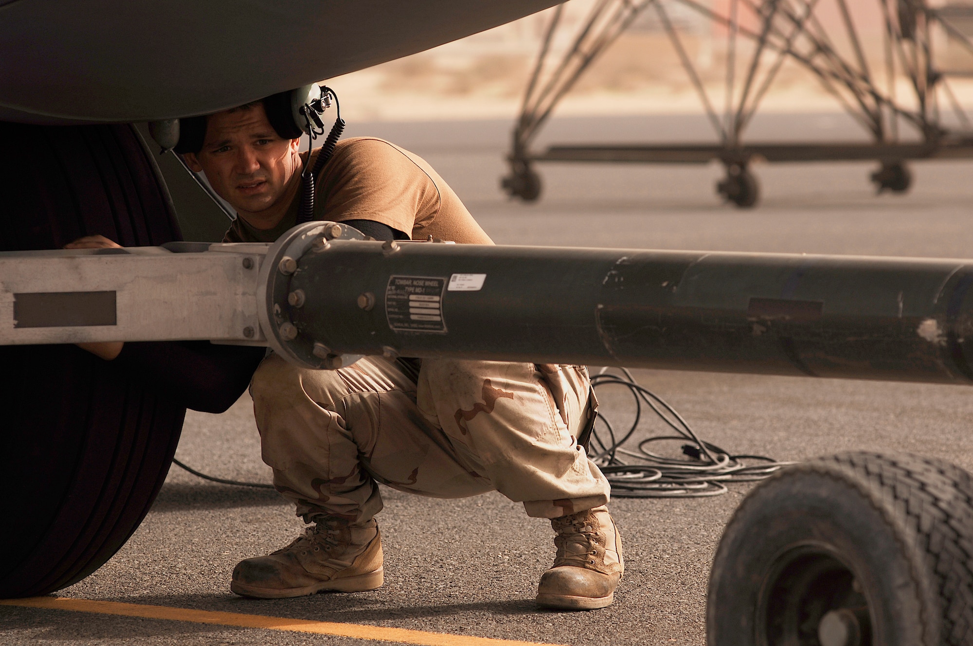 SOUTHWEST ASIA -- Senior Airman Justin Brown, a C-130 crew chief deployed to the 386th Expeditionary Aircraft Maintenance Squadron, is connecting a tow bar to a 43rd Expeditionary Airlift Squadron C-130 Hercules at a Southwest Asia air base Jan. 31, 2008. Airman Brown is deployed from Pope Air Force Base, S.C., and is responsible for ensuring the aircraft is kept mission capable to support Operations Enduring and Iraqi Freedom. (U.S. Air Force photo/ Staff Sgt. Patrick Dixon)