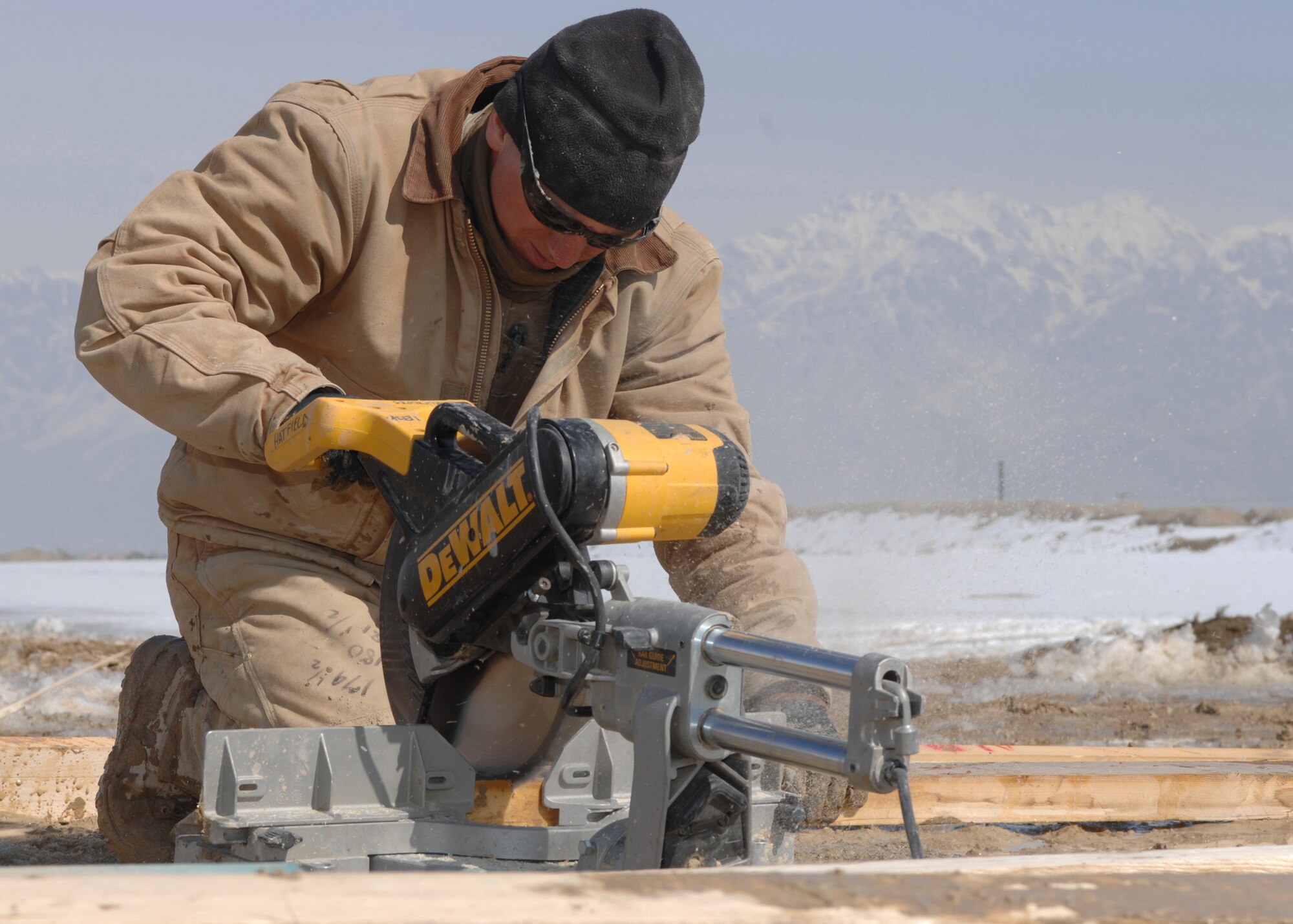 BAGRAM AIR BASE, Afghanistan - Staff Sgt. Levesque Lucas, 1st Expeditionary RED HORSE Group structural craftsman, cuts wood with a saw during construction on a barrier arresting kit on the flightline here Feb. 13. Levesque is from 819th RED HORSE Squadron, Malmstrom Air Force Base, Mont. (U.S. Air Force photo by Master Sgt. Demetrius Lester)