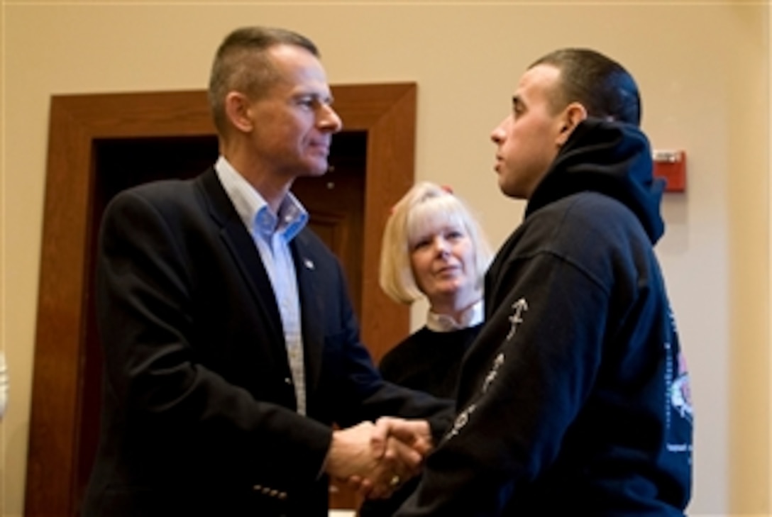 Retired U.S. Marine Corps Gen. Peter Pace and his wife, Lynne, greet a servicemember during a Valentine's Day luncheon at Marine Barracks, Washington,  Feb. 16, 2008. The luncheon, hosted by the former chairman of the Joint Chiefs of Staff and his wife and supported by the USO, honored wounded warriors and their families. 