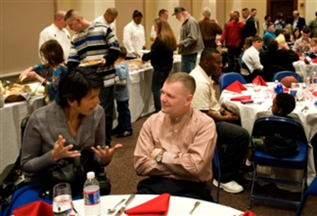 U.S. Army Staff Sgt. Liliana Caparo shares her observations of Walter Reed and the Veterans Affairs program with Vice Chairman of the Joint Chiefs of Staff Marine Gen. James Cartwright during a Valentine's Day luncheon at Marine Barracks, Washington, D.C., Feb. 16, 2008. 