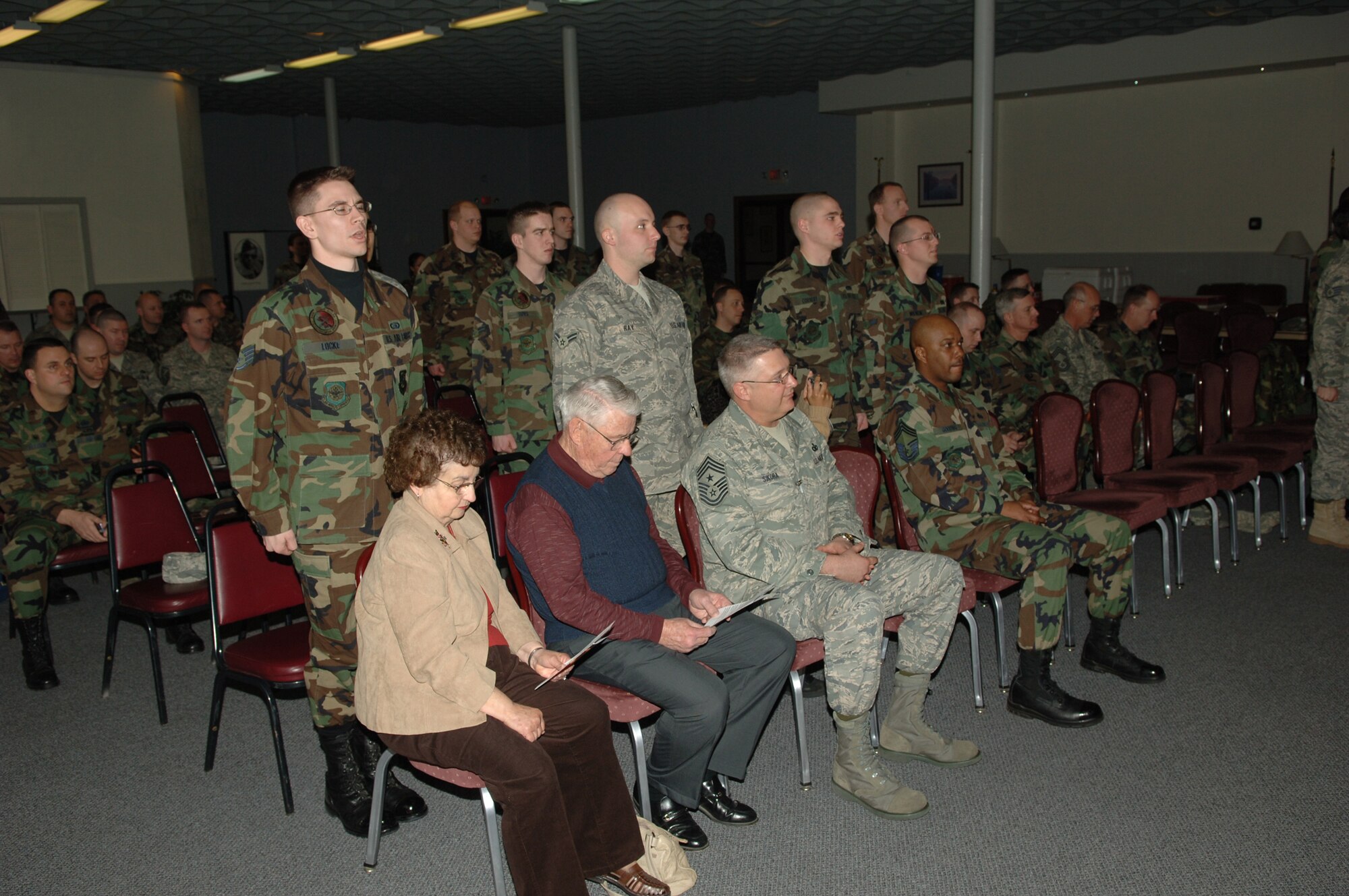 FAIRCHILD AIR FORCE BASE, Wash. -- Airmen, non-commissioned officers and officers recite the Honor Guard Creed during an honor guard graduation ceremony at the Deel Community Center here Feb. 15. Chief Master Sgt. Robert Gaylor (ret.), the fifth Chief Master Sergeant of the Air Force, and his wife were honorary guests at the graduation. (U.S. Air Force photo / Senior Airman Jocelyn Ford)