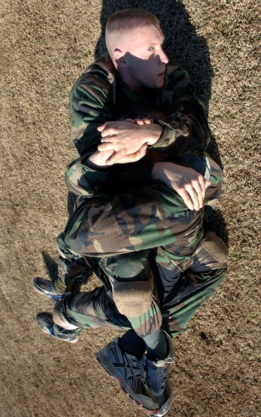 Air Force officer trainees practice close-combat tactics Feb. 8 during the new Air Force Combative Program field exercise at the Officer Training School at Maxwell Air Force Base, Ala.  All officer accession students are being given 11 hours of combative-skills training. Trainees learn ground fighting and basic jujitsu-style grappling moves to provide them with the confidence they need to defend themselves in combat situations.  (U.S. Air Force photo/Staff Sgt. Bennie J. Davis III) 