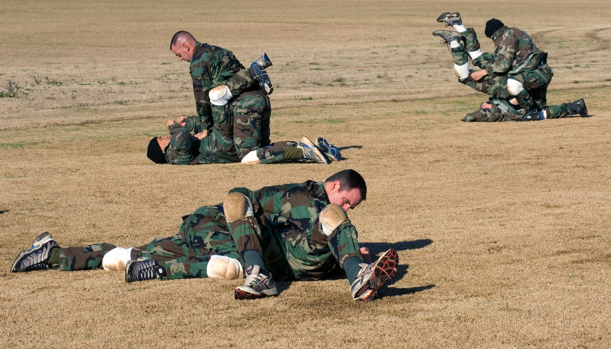 Air Force officer trainees practice close-combat tactics Feb. 8 during the new Air Force Combative Program field exercise at the Officer Training School at Maxwell Air Force Base, Ala.  All officer accession students are being given 11 hours of combative-skills training. Trainees learn ground fighting and basic jujitsu-style grappling moves to provide them with the confidence they need to defend themselves in combat situations.  (U.S. Air Force photo/Staff Sgt. Bennie J. Davis III) 