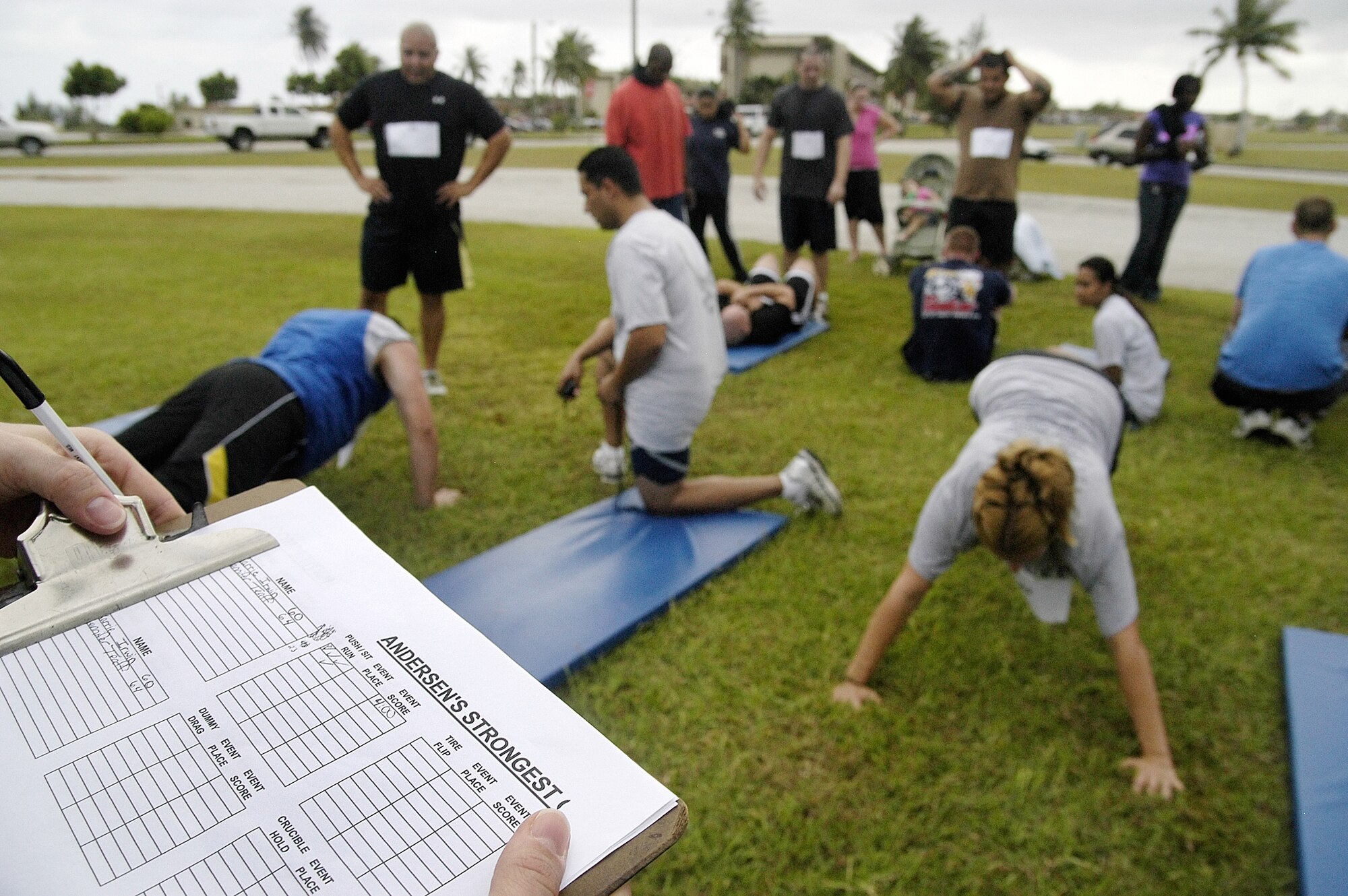 Strongman Challenge participants were scored on their performance during the Push up/sit up/run combo, truck pull, tire flip, military press, dummy drag, crucible hold and farmers walk. (U.S. Air Force photo by Master Sgt. Lisa M. Zunzanyika)