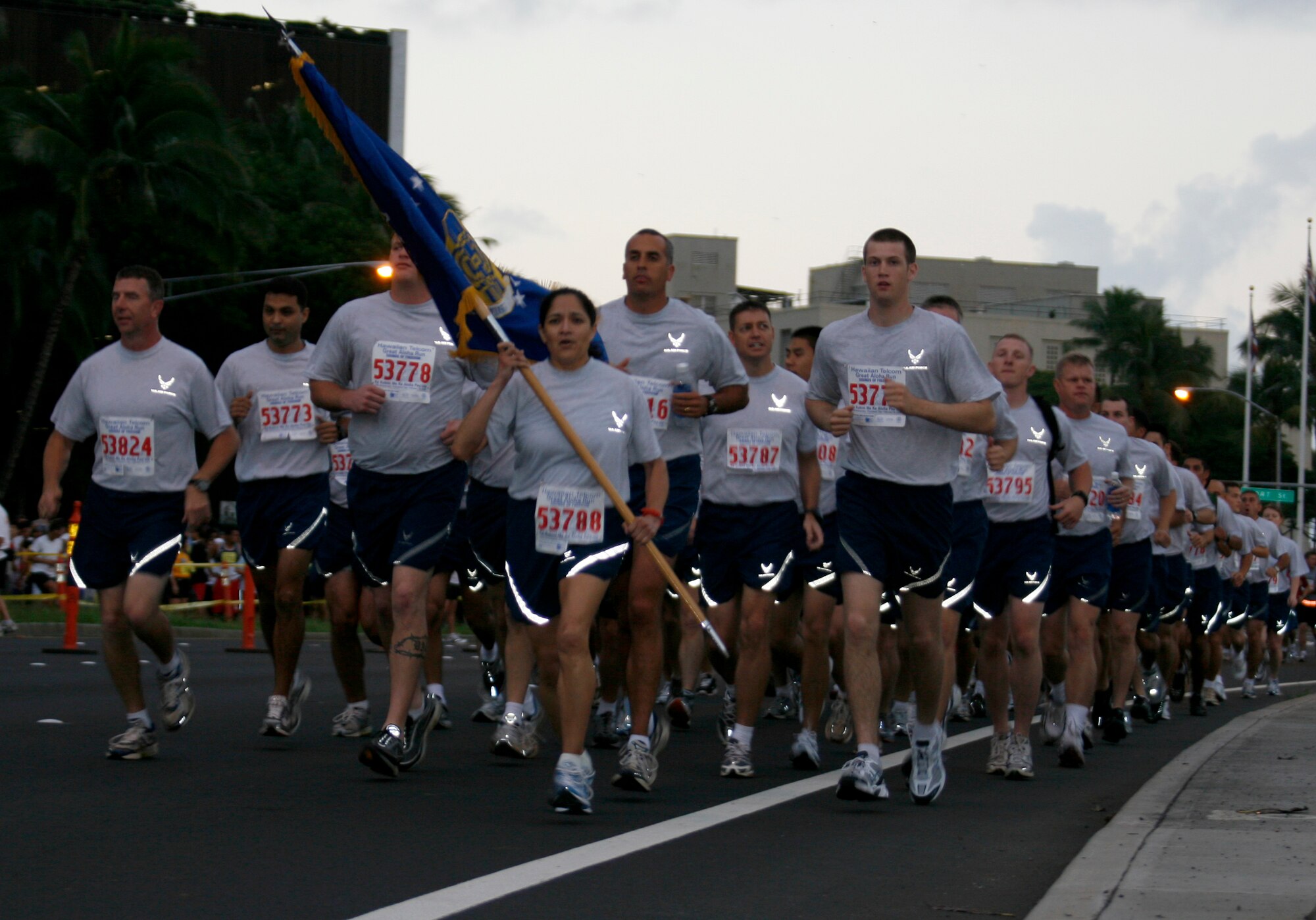 A formation of Team Hickam runners take off from the Aloha Tower  at 7 a.m. during the annual Hawaiian Telecom Great Aloha Run, Feb. 18. Around 21,000 participants came out for the event, which has raised mmore than $7.8 million for Hawaii's non-profit organizations and community groups. Photo by Staff Sgt. Erin Smith.