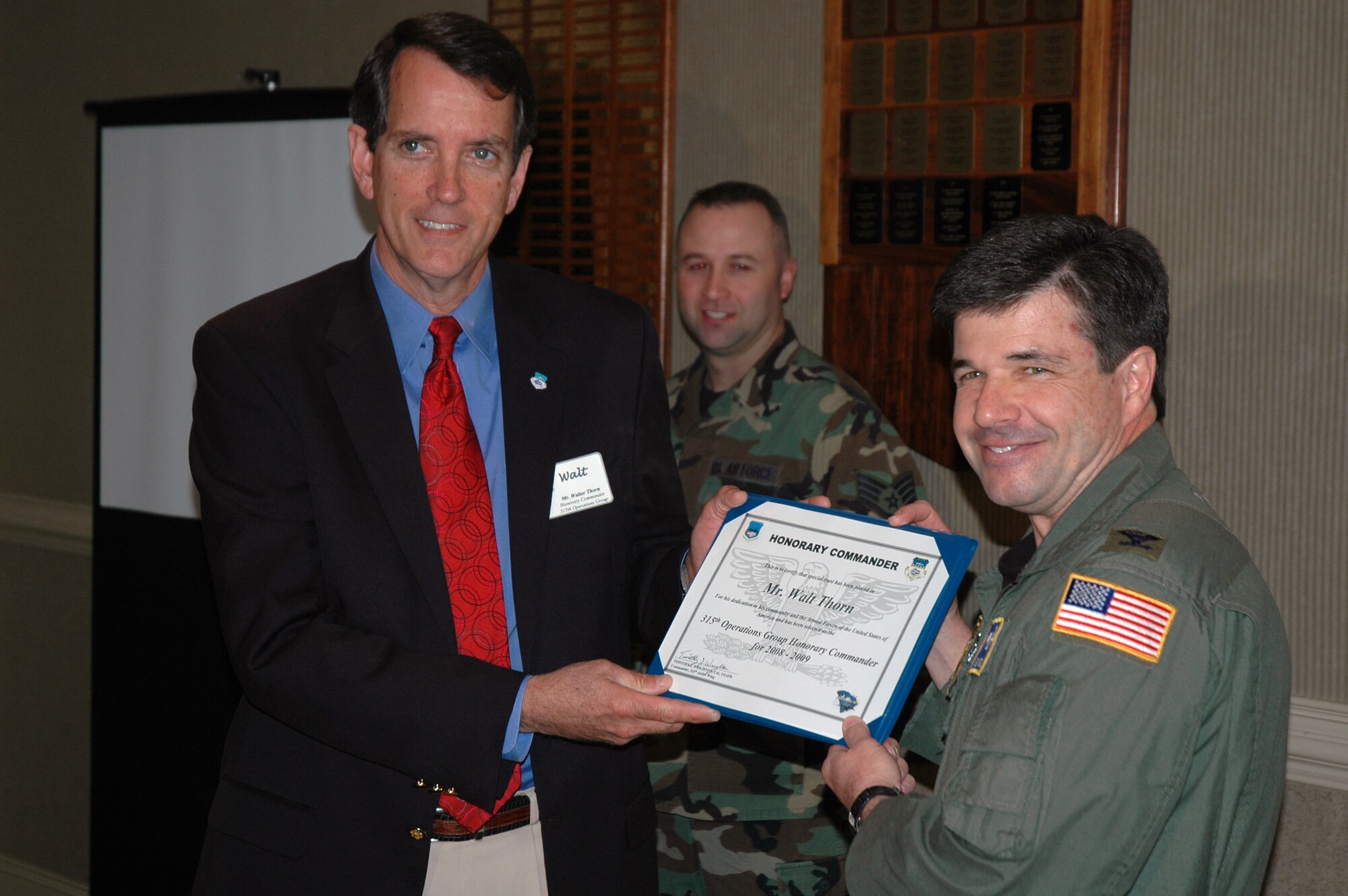 Walt Thorn (left) is presented a certificate by Col. Bill Edwards, the 315th Operations Group commander in a ceremony recognizing a new group of honorary commanders.  (Photo by Capt. Wayne Capps, USAFR)