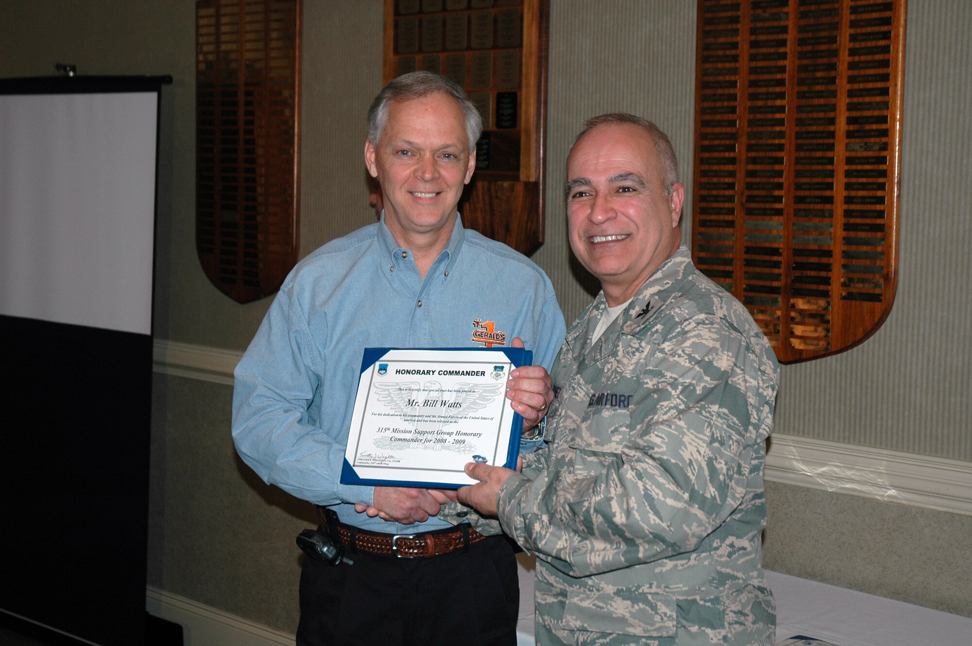 Bill Watts (left) is presented a certificate by Col. Luis Vazquez, the 315th Mission Support Group commander in a ceremony recognizing a new group of honorary commanders.  (Photo by Capt. Wayne Capps, USAFR)