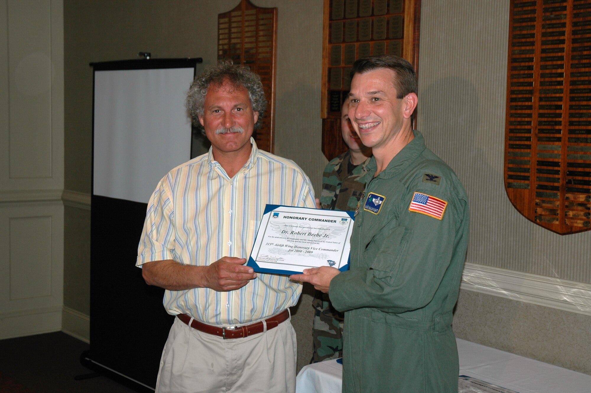 Dr. Robert Beebe (left) is presented a certificate by Col. Mark Bauknight, the 315th Airlift Wing vice commander in a ceremony recognizing a new group of honorary commanders.  (Photo by Capt. Wayne Capps, USAFR)