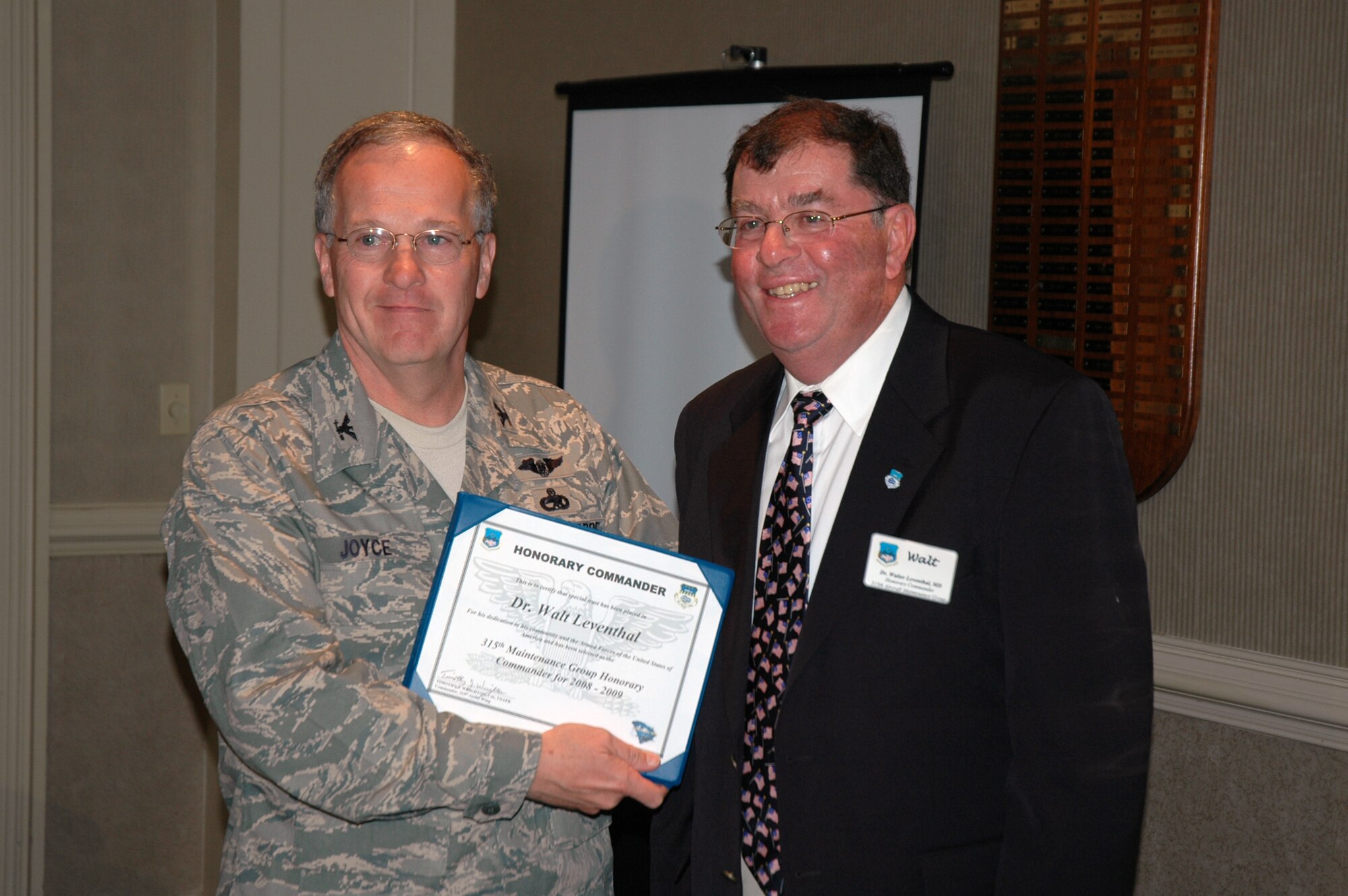 Walt Leventhal (right) is presented a certificate by Col. Jim Joyce, the 315th Maintenance Group commander in a ceremony recognizing a new group of honorary commanders.  (Photo by Capt. Wayne Capps, USAFR)