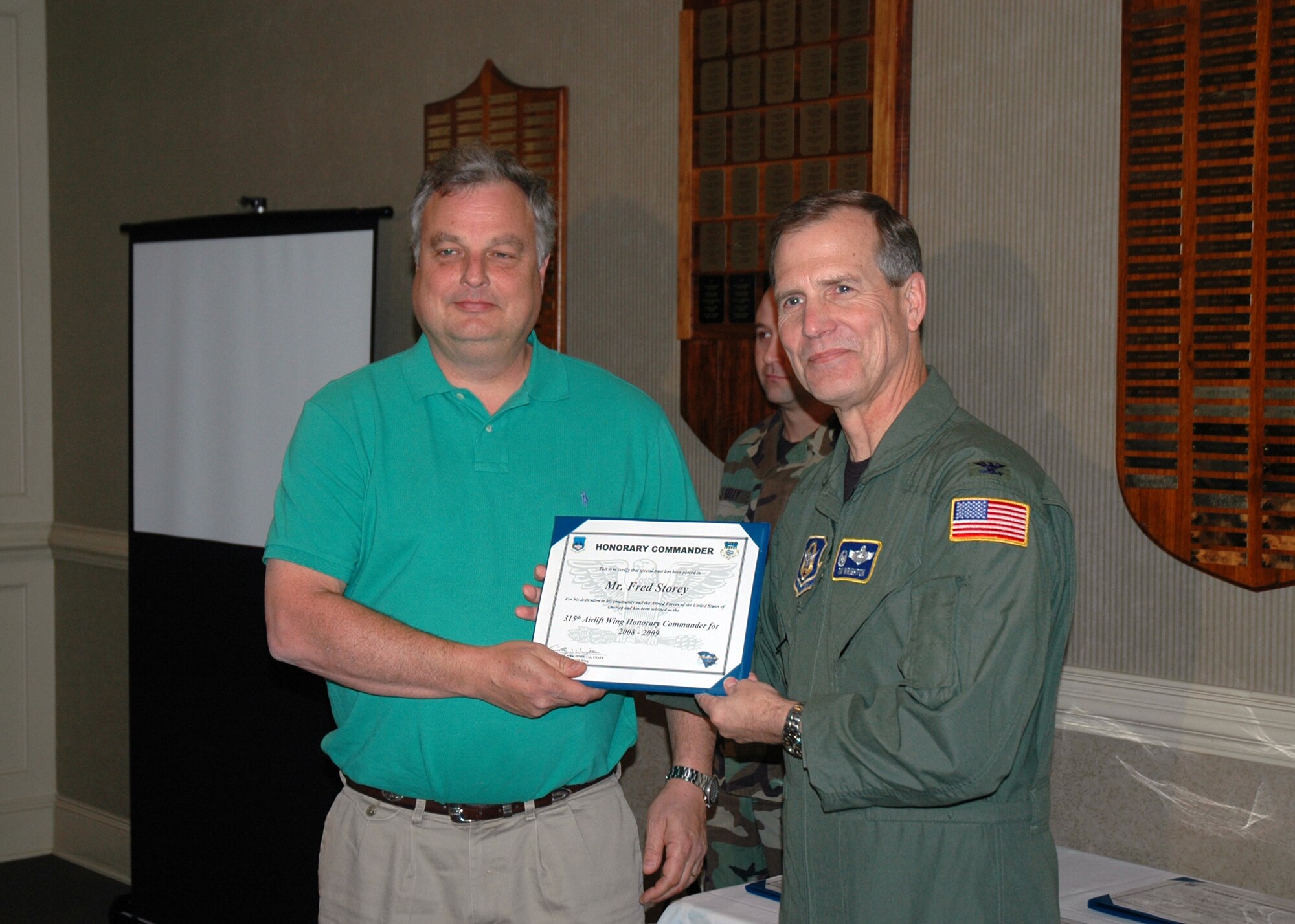 Fred Story (left) is presented a certificate by Col. Tim Wrighton, the 315th Airlift Wing commander in a ceremony recognizing a new group of honorary commanders.  (Photo by Capt. Wayne Capps, USAFR)