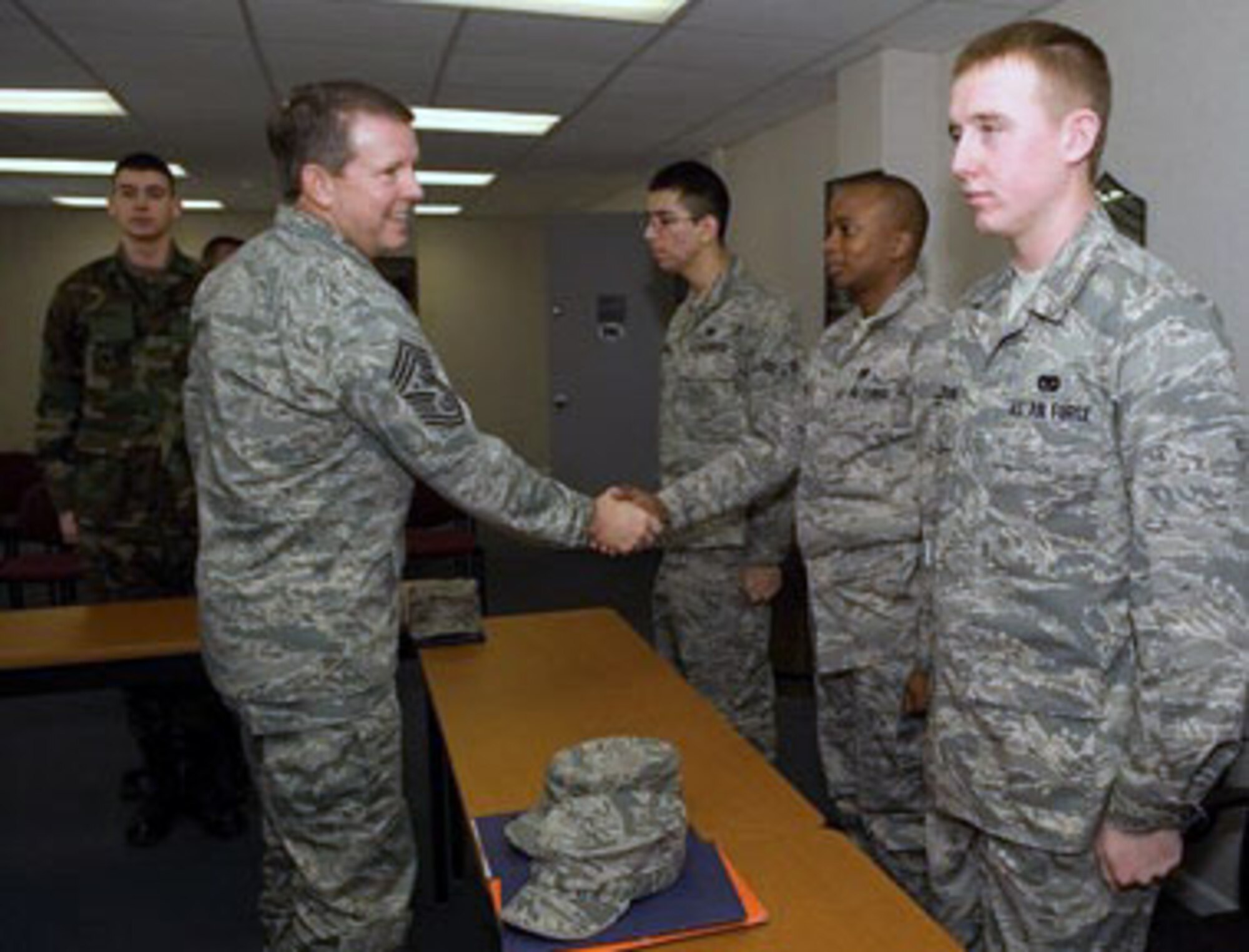 Airman Basic Alexander Timchula, Airmen 1st Class Jose Vizcarra, John Ntwiga and Clayton Jackson meet Chief Master Sgt. of the Air Force Rodney J. McKinley at the First Term Airman Center Feb. 11 at Dover Air Force Base, Del. Chief McKinley lauded Basic Military Training, technical schools and FTAC for generating first-rate Airmen and expressed necessity for peer Airmen and supervisors to continue in the mentorship of new Airmen. (U.S. Air Force photo/Jason Minto) 
