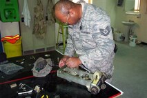 SEYMOUR JOHNSON AIR FORCE BASE, N.C. -- Tech. Sgt. Stewart Hawkins, a reservist with the 916th Civil Engineer Squadron, works on a BAK-14 retractable hook-cable support system for use with aircraft arresting systems. Sergeant Hawkins is currently deployed to Al Udeid, Qatar as a power production craftsman.