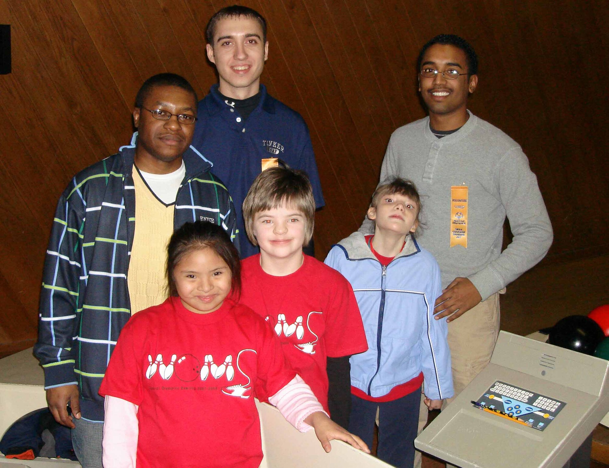 Airmen 1st Class Jerry Christopher, Chris Ashley and Roberto Sanchez, were among the more than 20 Airmen from the 72nd Security Forces Squadron who showed up at Holiday Lanes Bowing in Oklahoma City Jan. 11 to support the Oklahoma Special Olympics.  The 72nd SFS provided assistance to the athletes and scored the games for roughly 200 athletes who were trying to qualify for the national games.  (Courtesy photo)