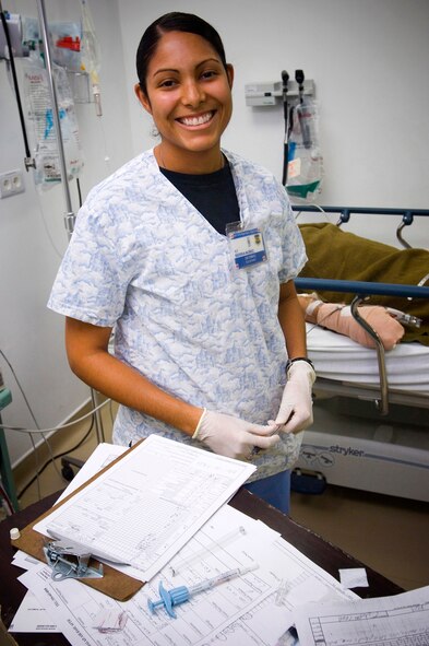 1st Lt. Johana Sierra-Nunez shares a sunny smile with the critically-injured patients she cares for in the Air Force Theater Hospital at Balad Air Base, Iraq. The lieutenant was a member of the medical team that cared for ABC news reporter Bob Woodruff, who was injuried while reporting on the war in Iraq. Lieutenant Sierra-Nunez is an intensive care unit nurse deployed from Lackland Air Force Base, Texas. (U.S. Air Force photo/Tech. Sgt. D. Clare) 