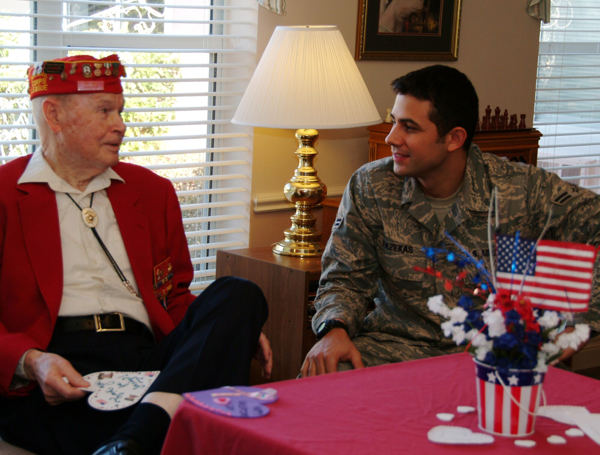 Airman 1st Class Michael Fazekas, 68th Electronic Warfare Squadron, visits with Marine and Air Force veteran Floyd Feb. 14 at the Sterling House in Niceville Fla.  More than 50 active duty 53d Wing members presented vets in nursing homes around the local area with cards and candy on Valentine's Day.  U.S. Air Force photo by Master Sgt. Andrew Leonhard.  