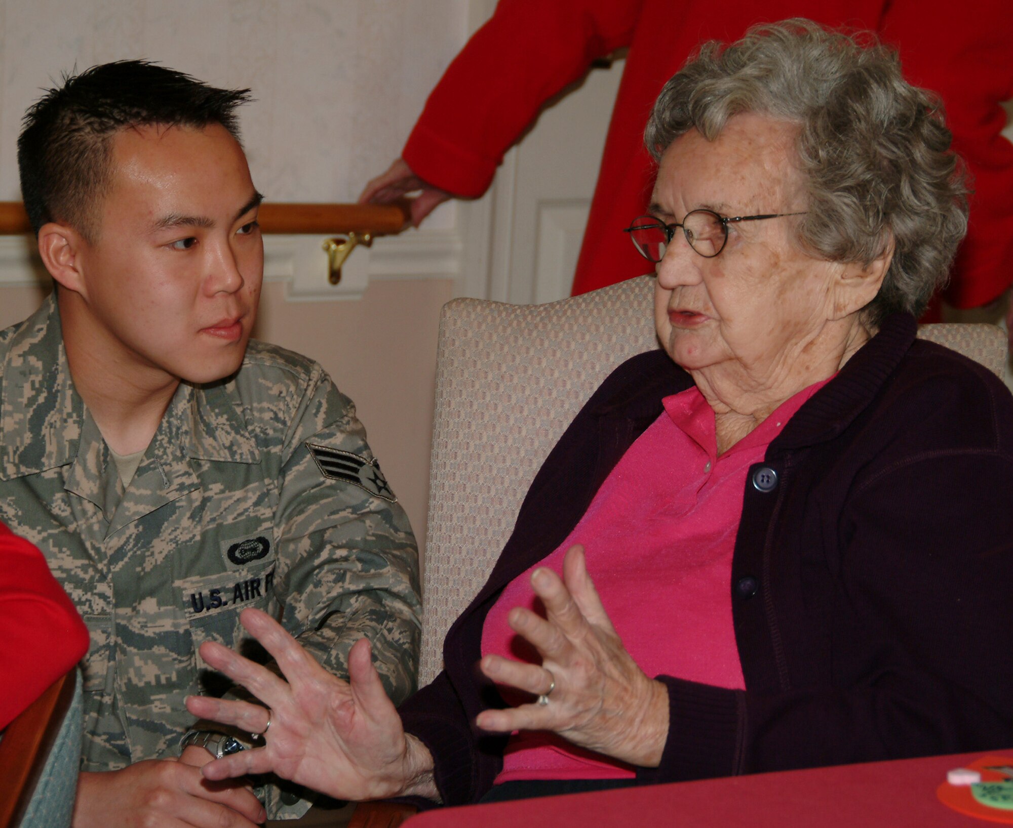 Senior Airman Steve Lee, 68th Electronic Warfare Squadron, talks with Juanita Feb. 14 at the Sterling House in Niceville Fla.  More than 50 active duty 53d Wing members presented vets in nursing homes around the local area with cards and candy on Valentine's Day.  U.S. Air Force photo by Master Sgt. Andrew Leonhard.  