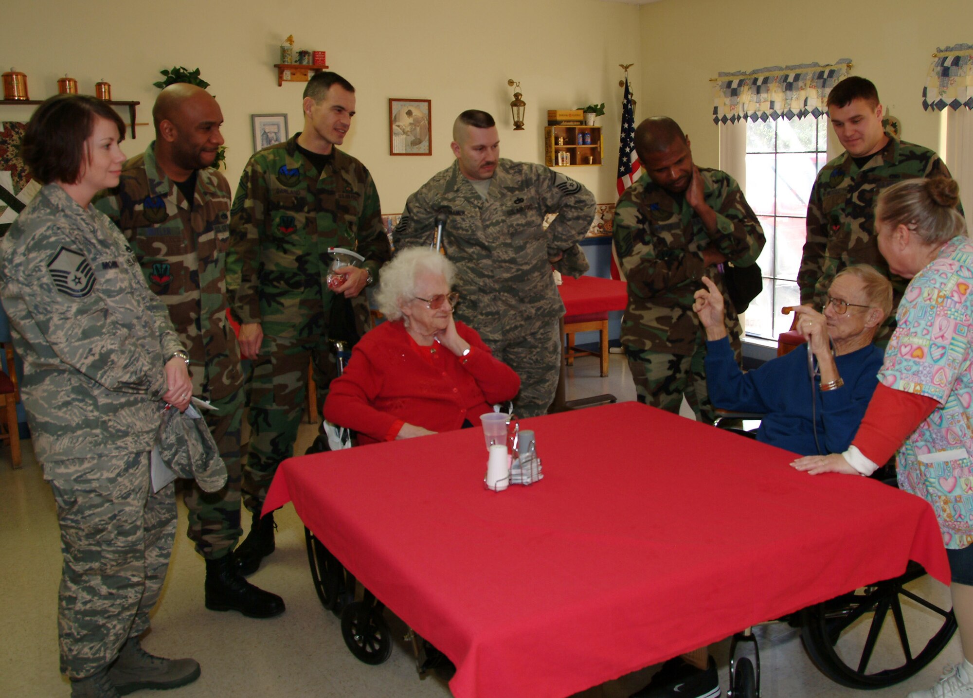 Members of the 53d Electronic Warfare Group visit with veteran Homer Guernsey and his wife Feb. 14 at the Silvercrest Rehabilitation Center in Crestview Fla.  More than 50 active duty 53d Wing members presented vets in nursing homes around the local area with cards and candy on Valentine's Day.  U.S. Air Force photo by Master Sgt. Andrew Leonhard.  