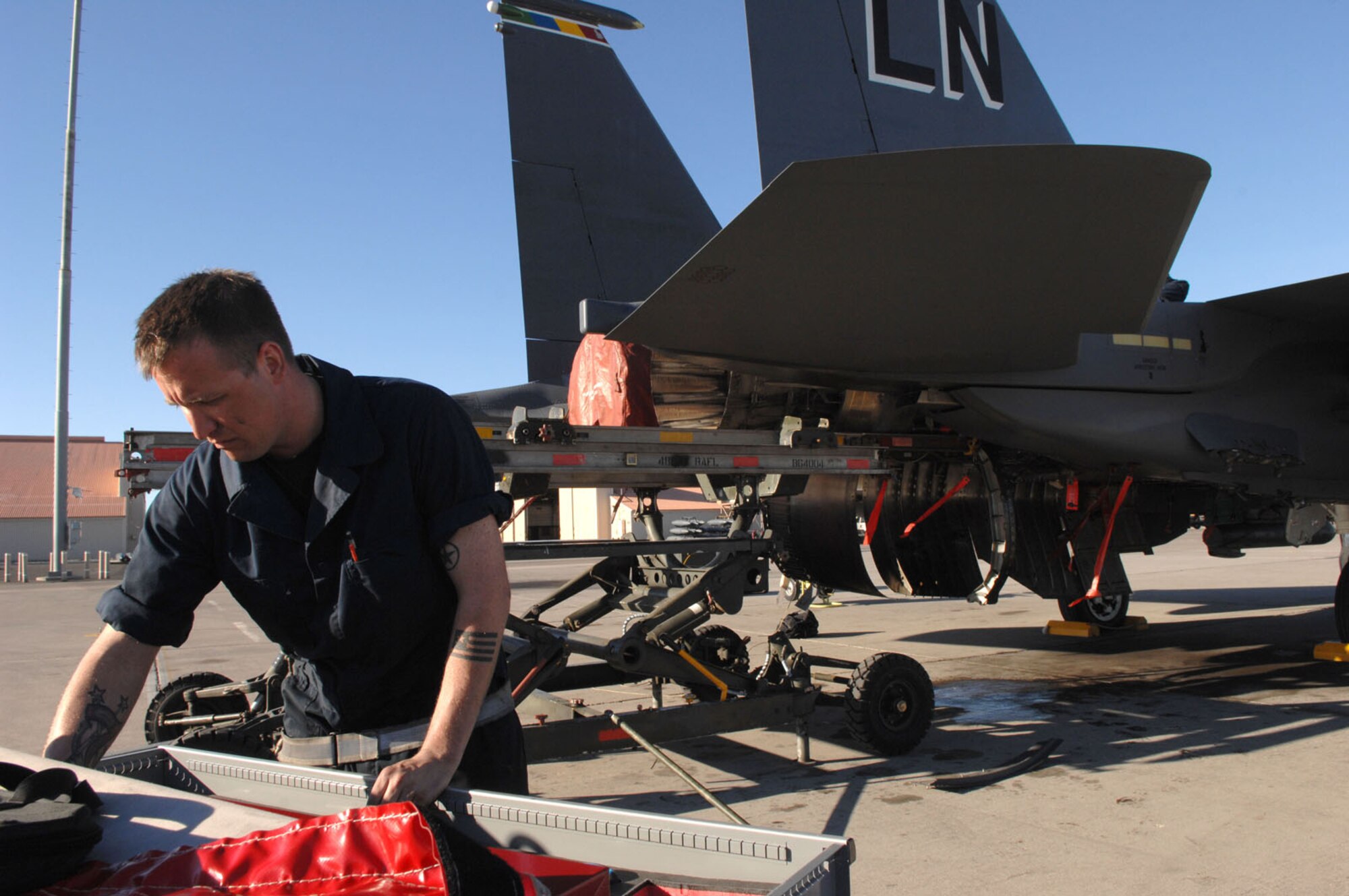 NELLIS AIR FORCE BASE, Nev.—Senior Airman Heath McGoldrick, a repair and reclamation journeyman assigned to the 48th Equipment Maintenance Squadron, Royal Air Force Lakenheath, England, prepares for routine maintenance on an F-15E Strike Eagle here Feb. 12. Red Flag is a multi-national exercise providing pilots with a realistic environment to practice combat scenarios. The experience gained during the exercise is vital to the survival of pilots in combat. (U.S. Air Force photo by Senior Airman Larry E. Reid Jr.)