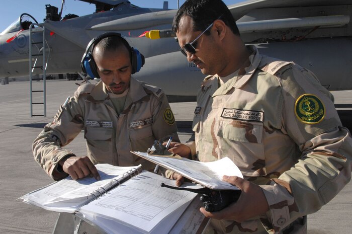 NELLIS AIR FORCE BASE, Nev.—Royal Saudi air force Sgts. Qassim Al-Ghazwani (left) and Amri Mansour, both crew chiefs assigned to the 6th Squadron, review maintenance technical orders for the F-15S during Red Flag here Feb. 12. Red Flag is a multi-national exercise providing pilots with a realistic environment to practice combat scenarios. The experience gained during the exercise is vital to the survival of pilots in combat. (U.S. Air Force photo by Senior Airman Larry E. Reid Jr.)