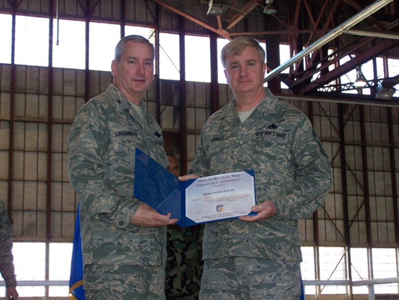 SEYMOUR JOHNSON AIR FORCE BASE, N.C. -- Chief Master Sgt. Bill McKInley (right)  receives a Get One award from Col. Fritz Linsenmeyer, wing commander of the 916th Air Refueling Wing. The Get One award is presented by the Reserve wing's recruiting office to current members who have made a referral resulting in a new member joining the Air Force Reserve. U.S. Air Force photo/Tech. Sgt. Ian Gardner