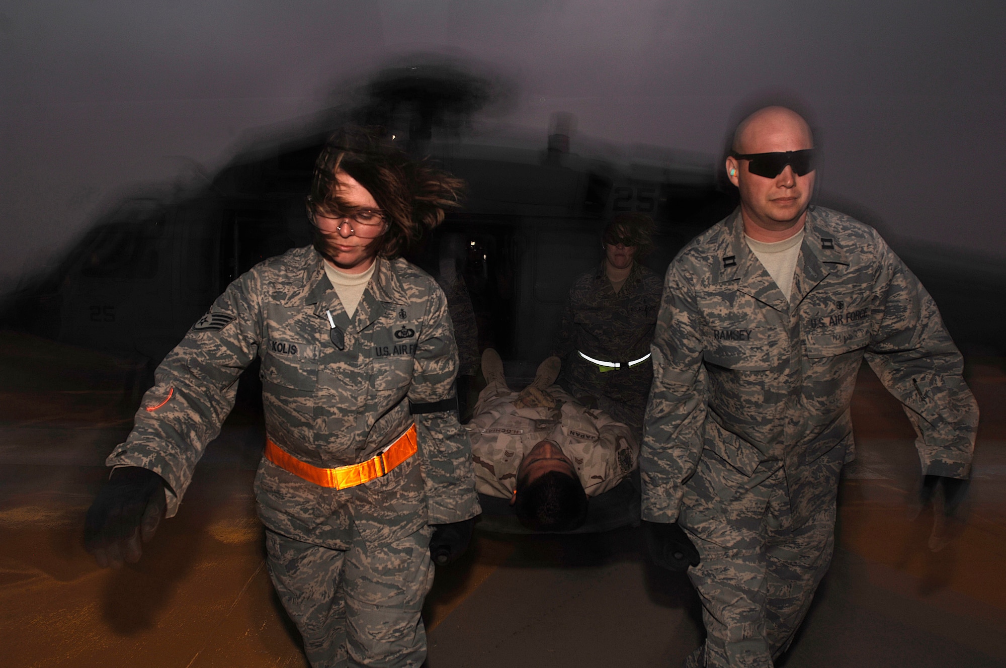 SOUTHWEST ASIA -- Staff Sgt. Christi Kolis, Capt. Kevin Ramsey, and Maj. Adrienne Goodknight (back right), from the 386th Expeditionary Medical Group, move a member from the Japan Air Self-Defense Force from an U.S. Navy MH-60 Sierra helicopter during an Air Force, Navy, and coalition litter management system training class at an air base in the Persian Gulf Region Feb. 18, 2008. The training familiarizes medical personnel on the loading and extracting techniques of patients for medical evacuation missions in support of Operations Enduring and Iraqi Freedom. (U.S. Air Force photo/ Staff Sgt. Patrick Dixon)