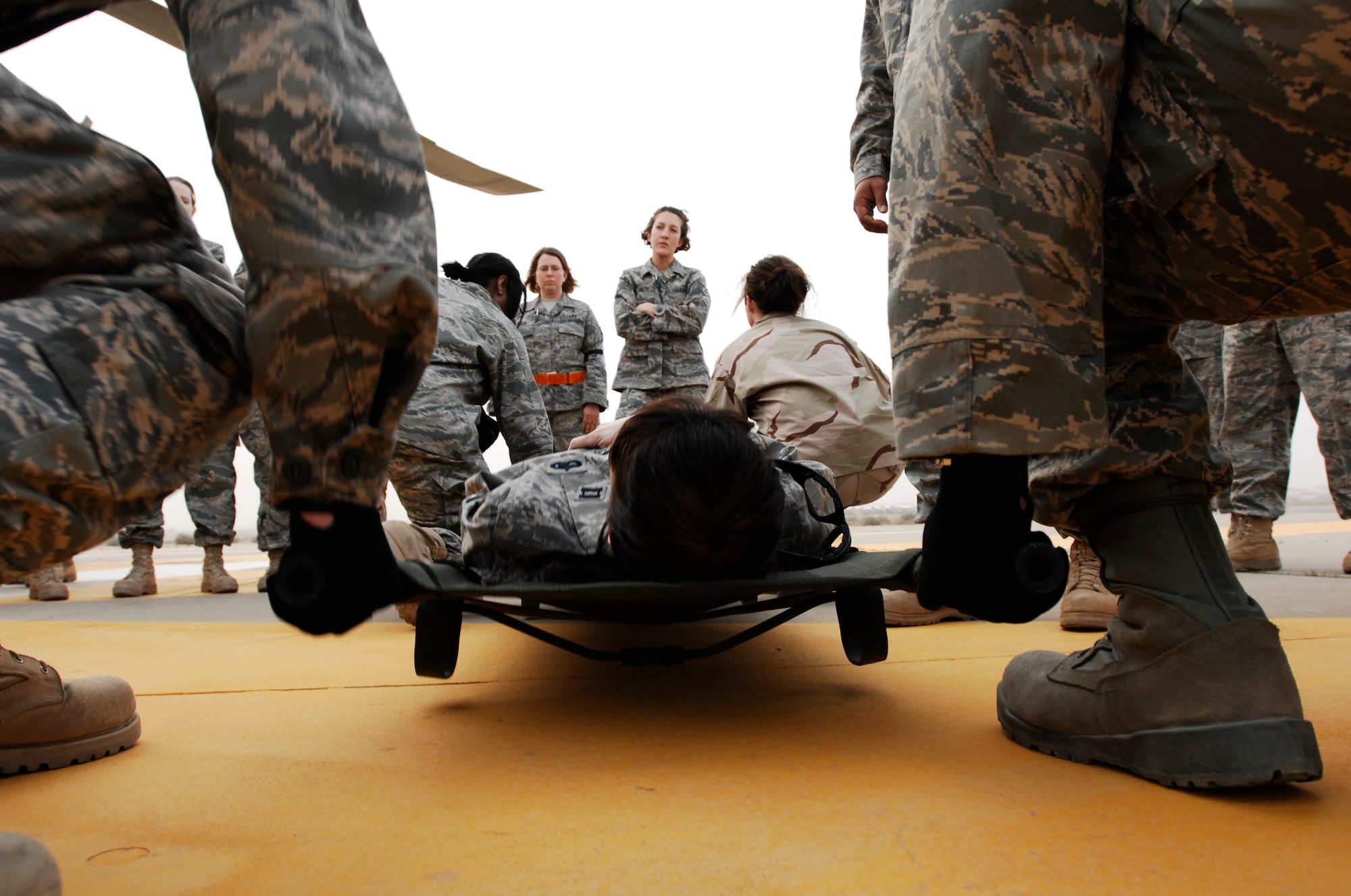 SOUTHWEST ASIA -- Members from the 386th Expeditionary Medical Group prepare to lift Capt. Loree Lunsford, a nurse from the 386th EMDG, during litter management system training at an air base in the Persian Gulf Region Feb. 18, 2008. The training familiarizes medical personnel on the loading and extracting techniques of patients for medical evacuation missions in support of Operations Enduring and Iraqi Freedom.  (U.S. Air Force photo/ Staff Sgt. Patrick Dixon) 