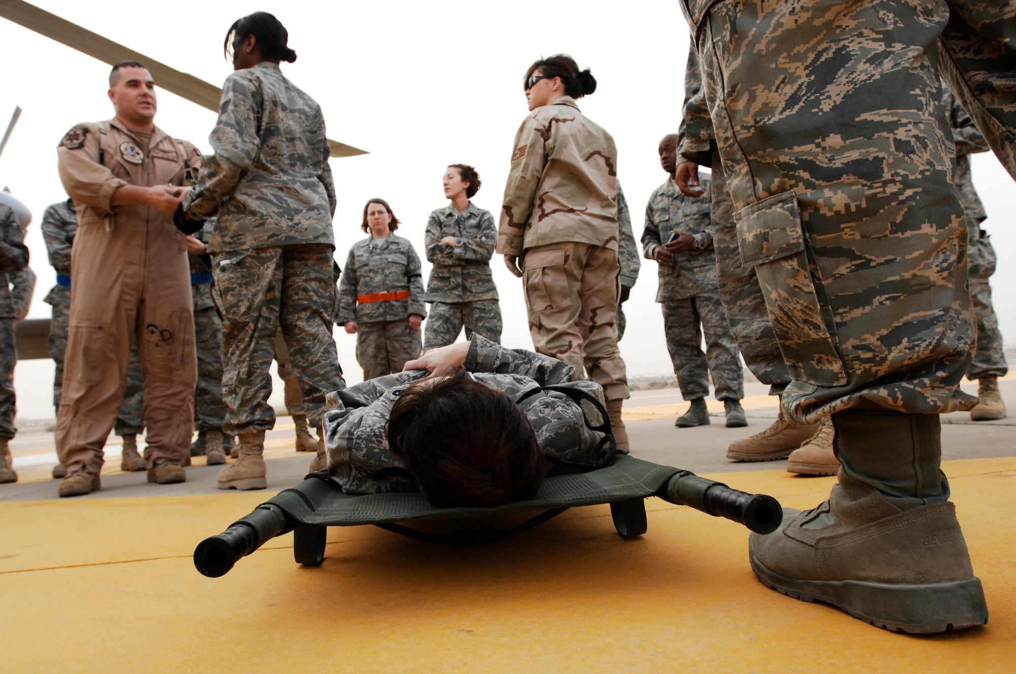SOUTHWEST ASIA -- U.S. Navy Hospital Corpsman 2nd Class Clayton Deese instructs members from the 386th Expeditionary Medical Group while Capt. Loree Lunsford, a nurse from the 386th EMDG, waits on a litter to be transported during litter management system training on a U.S. Navy MH-60 Sierra helicopter at an air base in the Persian Gulf Region Feb. 18, 2008. The training familiarizes medical personnel on the loading and extracting techniques of patients for medical evacuation missions in support of Operations Enduring and Iraqi Freedom.  (U.S. Air Force photo/ Staff Sgt. Patrick Dixon) 