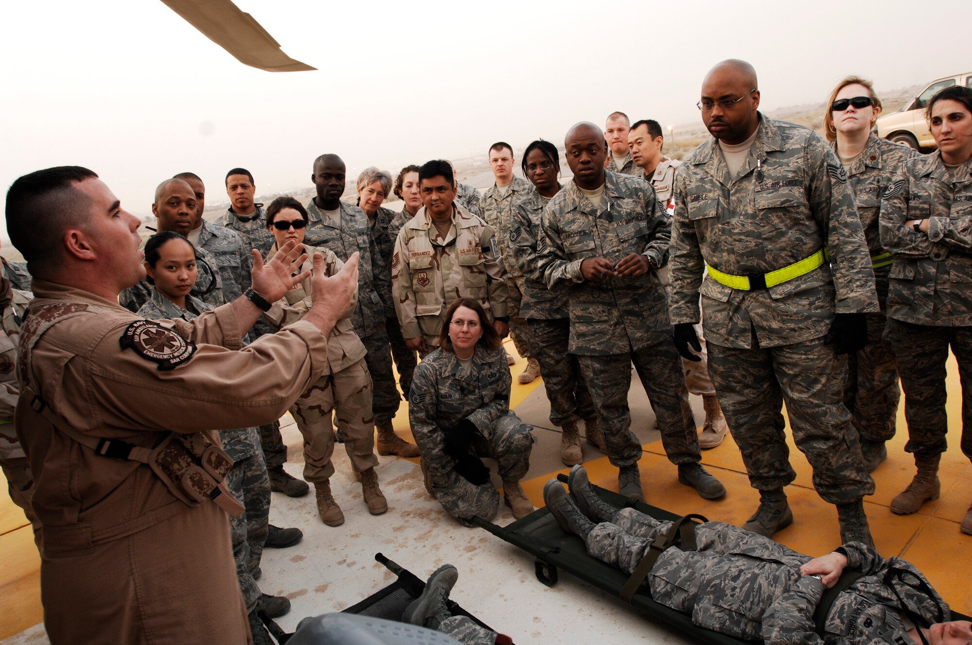 SOUTHWEST ASIA -- Members from the 386th Expeditionary Medical Group listen while U.S. Navy Hospital Corpsman 2nd Class Clayton Deese speaks about the litter management system on a U.S. Navy MH-60 Sierra helicopter at an air base in the Persian Gulf Region Feb. 18, 2008. The training familiarizes medical personnel on the loading and extracting techniques of patients for medical evacuation missions in support of Operations Enduring and Iraqi Freedom. (U.S. Air Force photo/ Staff Sgt. Patrick Dixon) 