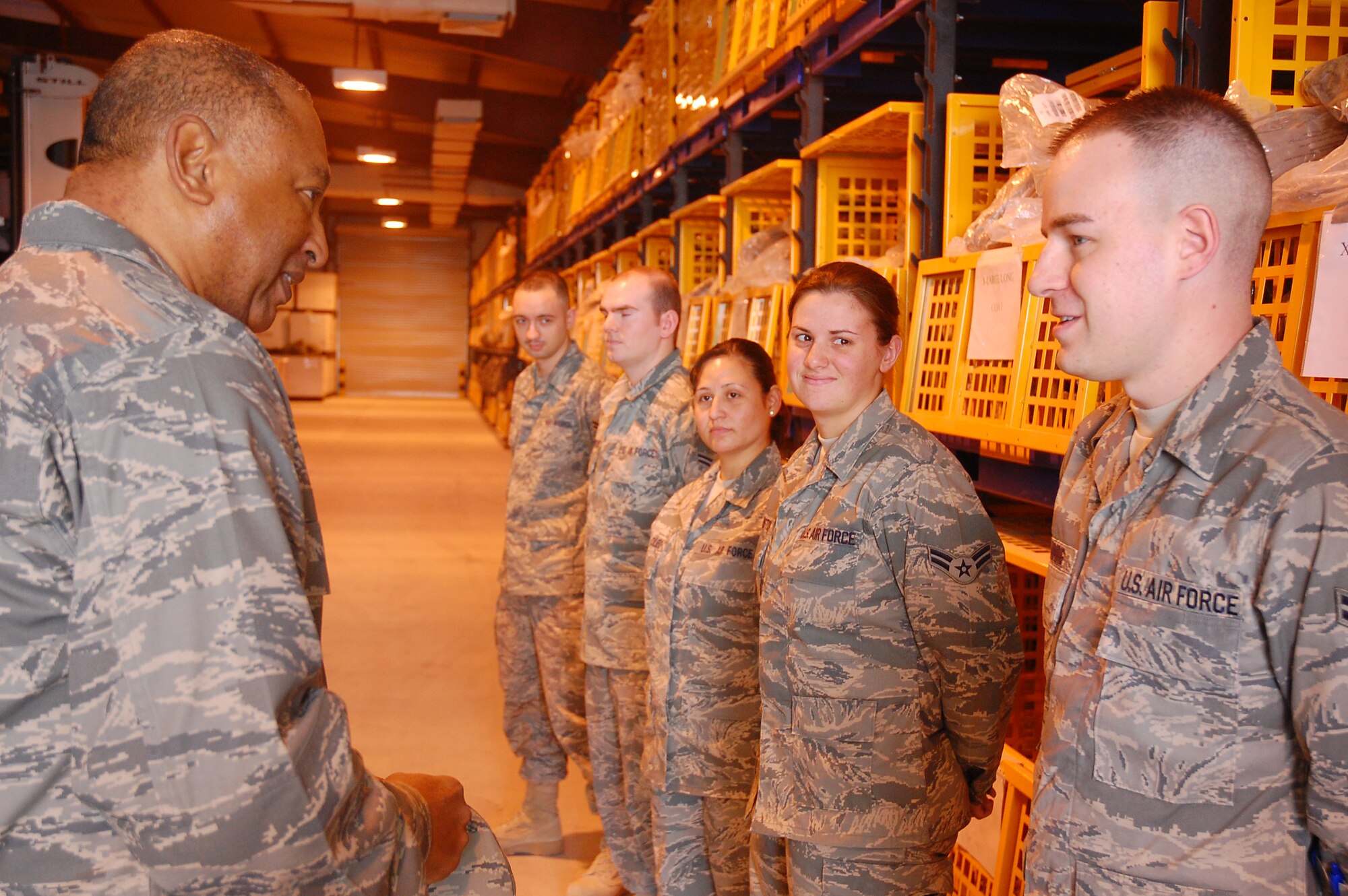 SOUTHWEST ASIA -- Major Gen. Gary T. McCoy, Director of Logistics Readiness, Office of the Deputy Chief of Staff for Logistics, talks with Airman 1st Class Daniel Lanning, 386th Air Expeditionary Logistics Readiness Squadron, during his last stop of five bases in the Central Command area of operations, Feb. 16, 2008. Airman Lanning is deployed from Charleston Air Force Base, S.C. and works at one of the three Expeditionary Theater Distribution Centers in the AOR. The center allows deploying Airmen to pick-up and return most of their required professional gear in-theater vs. having to carry it from their home station to the area of responsibility and back. (U.S. Air Force photo/Capt. Jason McCree)