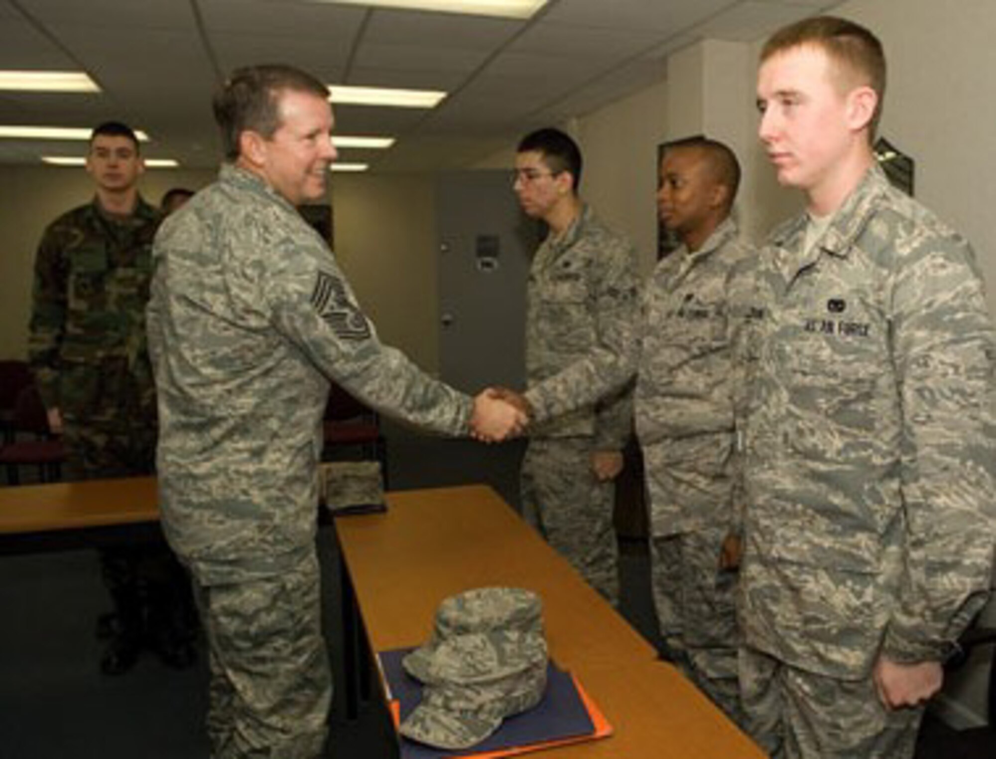 (Left to right) Airman Basic Alexander Timchula, Airman 1st Class Jose Vizcarra, Airman 1st Class John Ntwiga, and Airman 1st Class Clayton Jackson meet with the Chief Master Sgt. of the Air Force Rodney J. McKinley, at Dover’s First Term Airman Center, Feb. 11. Chief McKinley lauded basic military training, technical schools and FTAC for generating first-rate Airmen and expressed necessity for peer Airmen and supervisors to continue in the mentorship of new Airmen. (U.S. Air Force photo/Jason Minto)