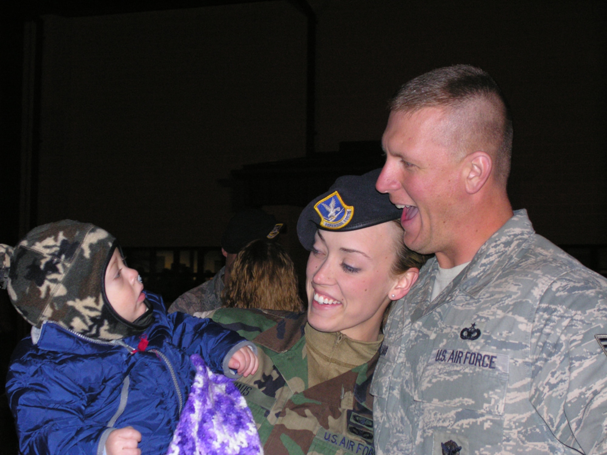 SEYMOUR JOHNSON AIR FORCE BASE, N.C. -- Tech. Sgt. Dan Paus greets his son, Connor, and wife, Staff Sgt. Brittany Paus, upon returning from a six-month deployment to Iraq.  Both are members of the 916th Air Refueling Wing Security Forces Squadron. U.S. Air Force photo/Capt. Shannon Mann