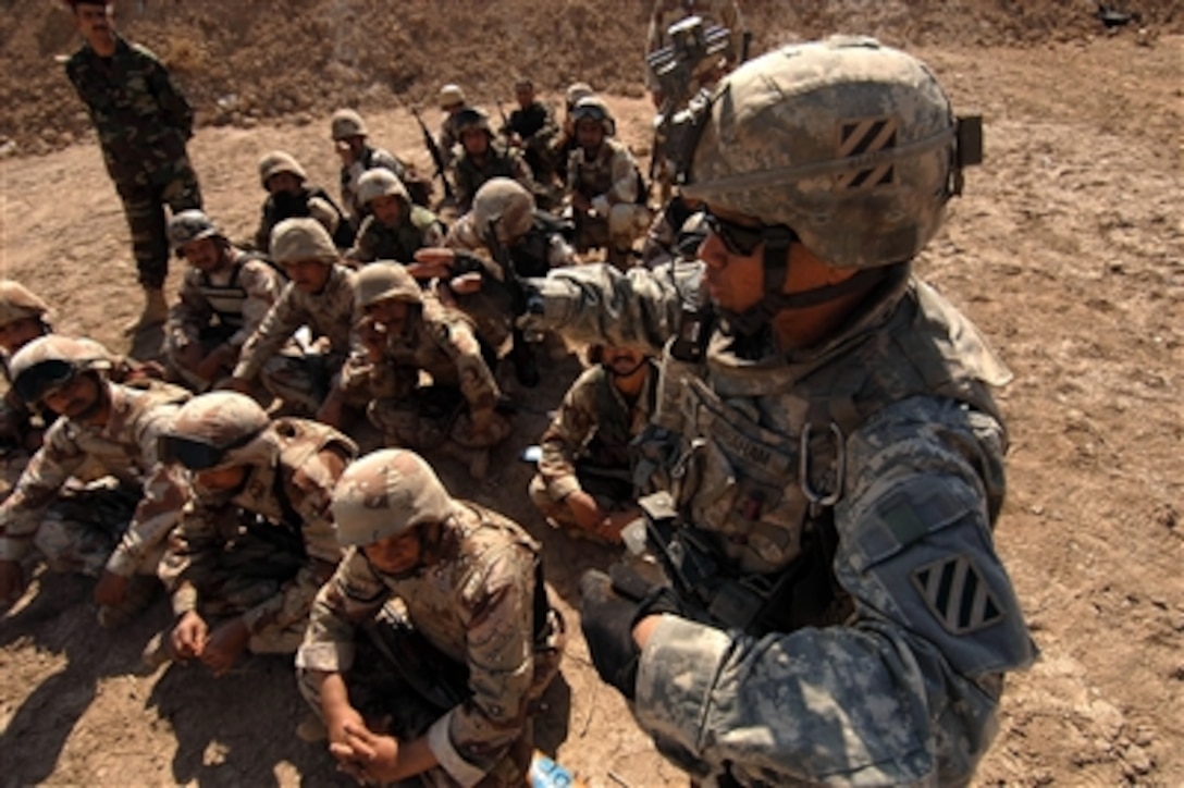 U.S. Army Staff Sgt. Ditson Abraham gives Iraqi army soldiers a class on dismounted tactical movement techniques during training at Tanmiya, Iraq, on Feb. 14, 2008.  Abraham and his fellow soldiers from the U.S. Army's 0832 Military Transition Team are training Iraqi army soldiers from the 2nd Light Infantry Battalion, 3rd Brigade Combat Team, 8th Army Division.  