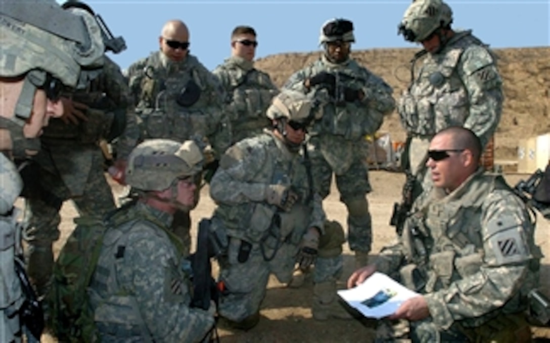 U.S. Army First Lt. Mike Barth, bottom right, briefs his soldiers before an upcoming patrol at Combat Outpost Cashe, Iraq, Feb. 12, 2008. Barth is assigned to the15th Infantry Regiment, 1st Battalion.