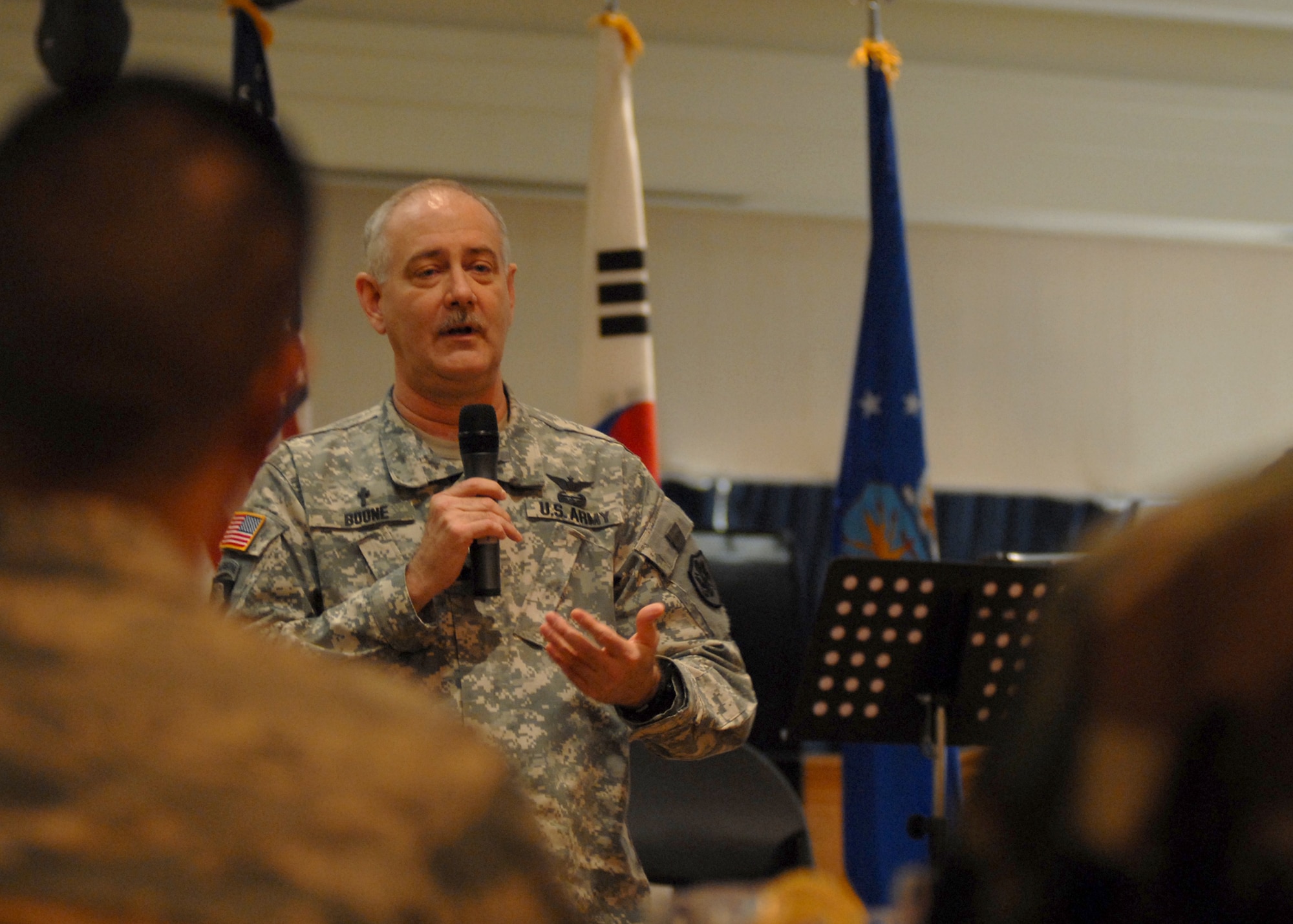 KUNSAN AIR BASE, South Korea— Chaplain (Col.) Samuel J.T. Boone, United States Forces Korea command chaplain, speaks to Airmen about his experiences here Feb. 21. The National Prayer Luncheon is a way for Airmen to assemble together in efforts to understand the need for prayer in their lives as well as getting a better understanding and greater appreciation for different religious beliefs.  (U.S. Air Force Photo/Staff Sgt Araceli Alarcon) 