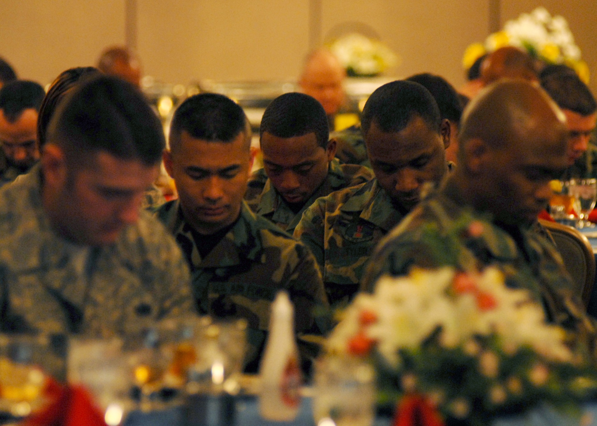KUNSAN AIR BASE, South Korea—  Airmen from the 8th Fighter Wing pray together during the “Prayer for Our Nation” given by Chaplain (Maj.) Marty Fitzgerald from the 8th Fighter Wing Chapel Feb. 21 here. The National Prayer Luncheon is a way for Airmen to assemble together in efforts to understand the need for prayer in their lives as well as getting a better understanding and greater appreciation for different religious beliefs.  (U.S. Air Force Photo/Staff Sgt Araceli Alarcon) 