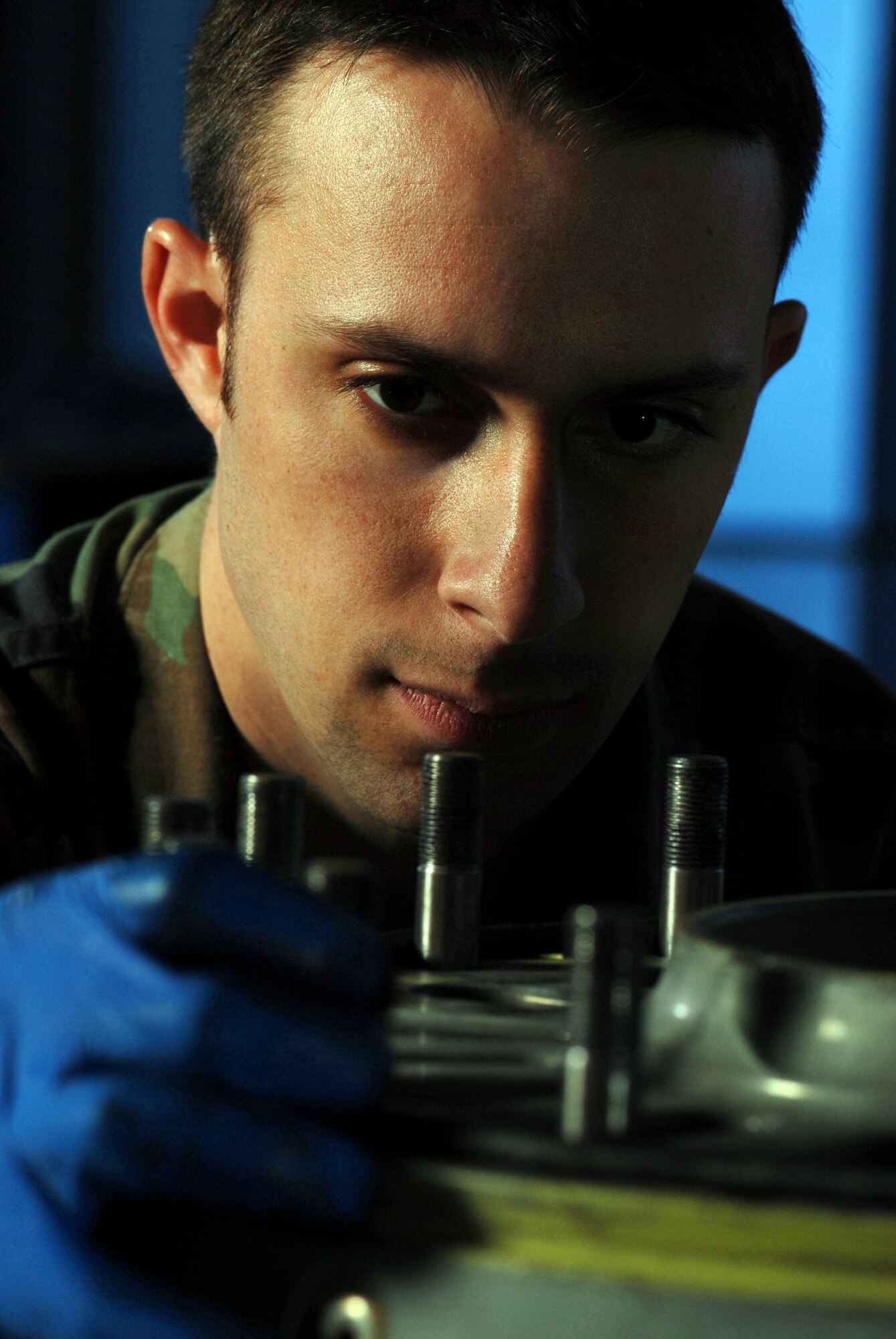 Staff Sgt. Greg Thompson, an aircraft mechanic from the Aero Repair Shop, visually inspect the bolts on a C-17 Globemasterr III cargo aircraft wheel at March Air Reserve Base, Calif., on Feb. 3, 2008. (U.S. Air Force photo by Val Gempis)