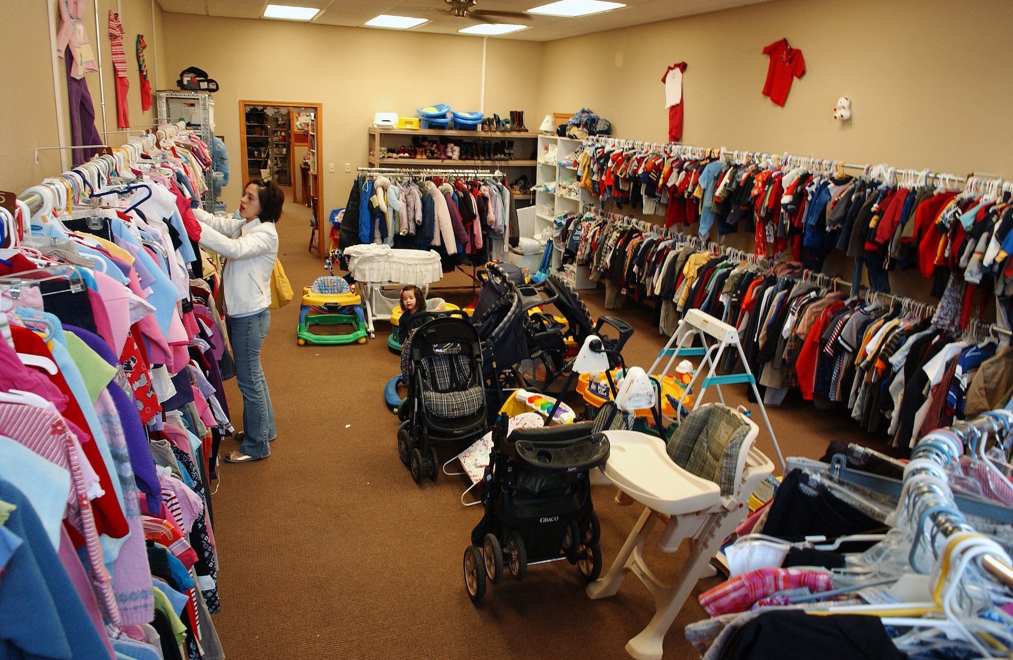 EIELSON AIR FORCE BASE, Alaska -- Tiziana Lundgren sorts through several items of clothing Feb. 20 at the Airman's Attic. The AA is sponsored by the chapel and is ran on a volunteer basis providing donated furniture, clothes and toys to all ranks and services families. She is the spouse of Staff Sgt. Matthew Lundgren of the 354th Operation Support Squadron. (U.S. Air Force Photo/Airman 1st Class Jonathan Snyder)