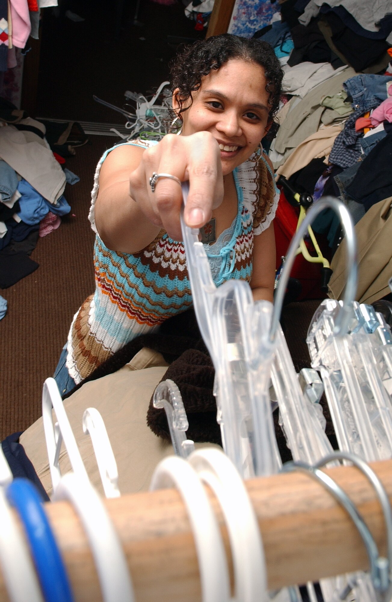 EIELSON AIR FORCE BASE, Alaska -- Michelle Eeles stores several empty hangers in storage Feb. 20 at the Airmen Attic. The Airmen Attic is sponsored by the Chapel and is ran on a volunteer basis providing donated furniture, clothes and toys to all ranks and services families. She is the spouse of Master Sgt. Robert Eeles of the 354th Comptroller Squadron. (U.S. Air Force Photo/Airman 1st Class Jonathan Snyder)