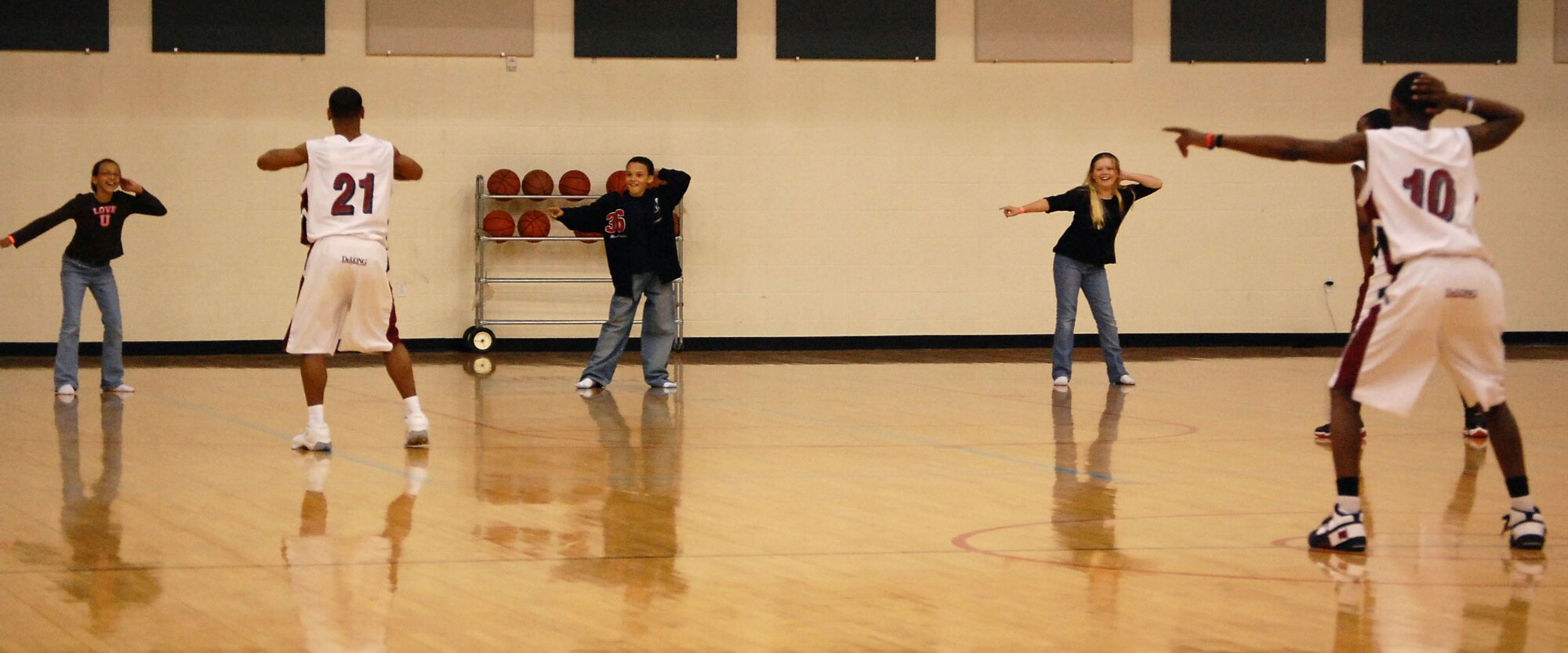 LAUGHLIN AIR FORCE BASE, Texas –Members from the Harlem Ambassadors basketball team play games with base children in between quarters during a game at the Losano Fitness Center Feb. 19. The Harlem Ambassadors battled Laughlin members in a friendly game of basketball that included a comedic half-time show with lots of crowd participation. (U.S. Air Force photo by Airman 1st Class Sara Csurilla) 