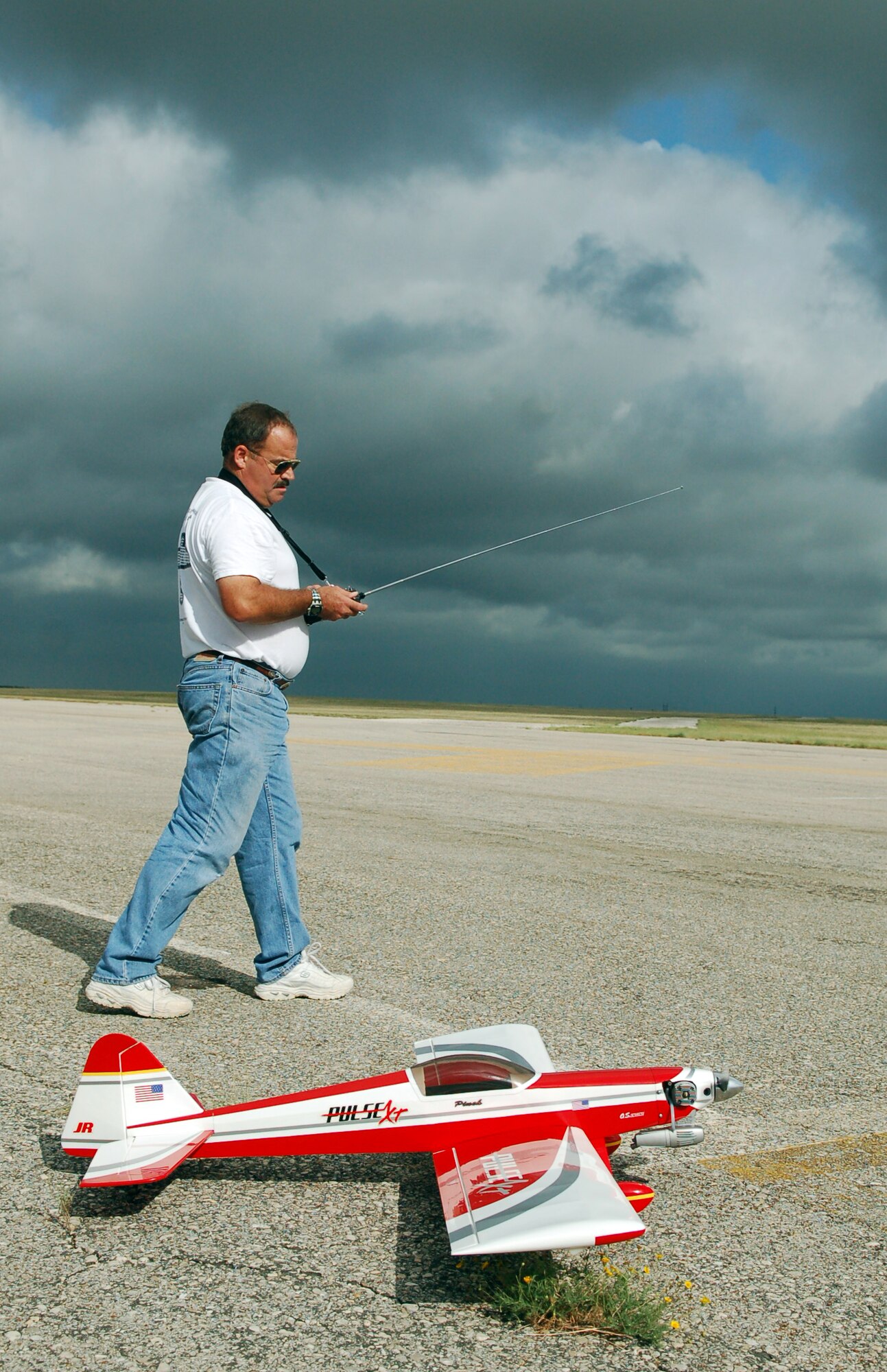 LAUGHLIN AIR FORCE BASE, Texas – Ted Glenn, lead T-1 simulator instructor here, taxis one of his scale aircraft onto an old runway on the Laughlin airfield in preparation for takeoff.  Glenn is a member of the Del Rio Dirt Flyers, a small group of radio-control aviation enthusiasts who fly at Laughlin when the airfield is closed.  (U.S. Air Force photo by Staff Sgt. Austin M. May)