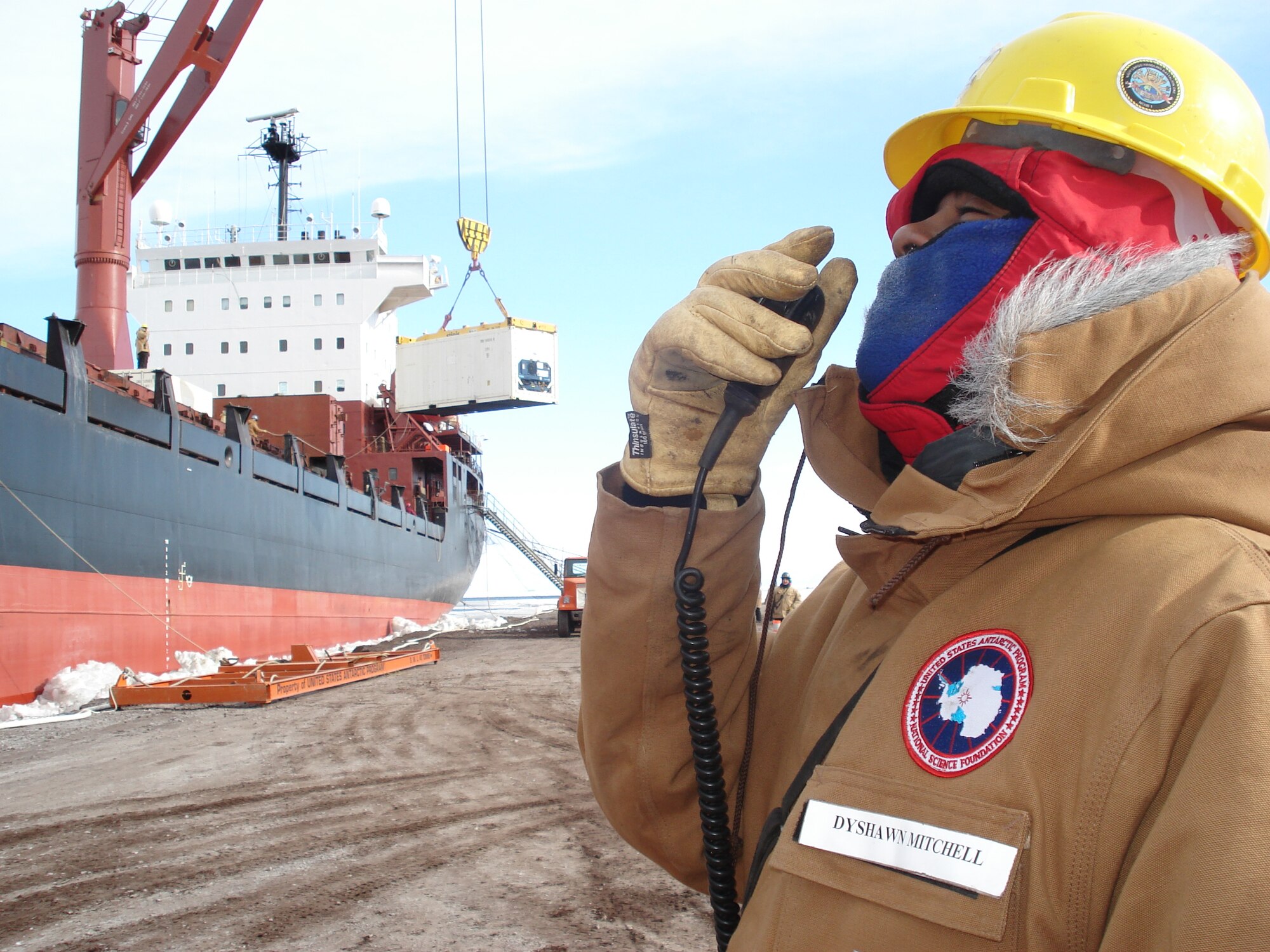 MCMURDO STATION, Antarctica--Electrician's Mate 2nd Class Dyshawn Mitchell observes the cargo handling efforts of his shipmates in Navy Cargo Handling Battalion One as they unload cargo from the Military Sealift Command ship, MV American Tern, for scientists at McMurdo Station in Antarctica as part of Operation Deep Freeze. (U.S. Navy photo by Lt. Sean Spicer